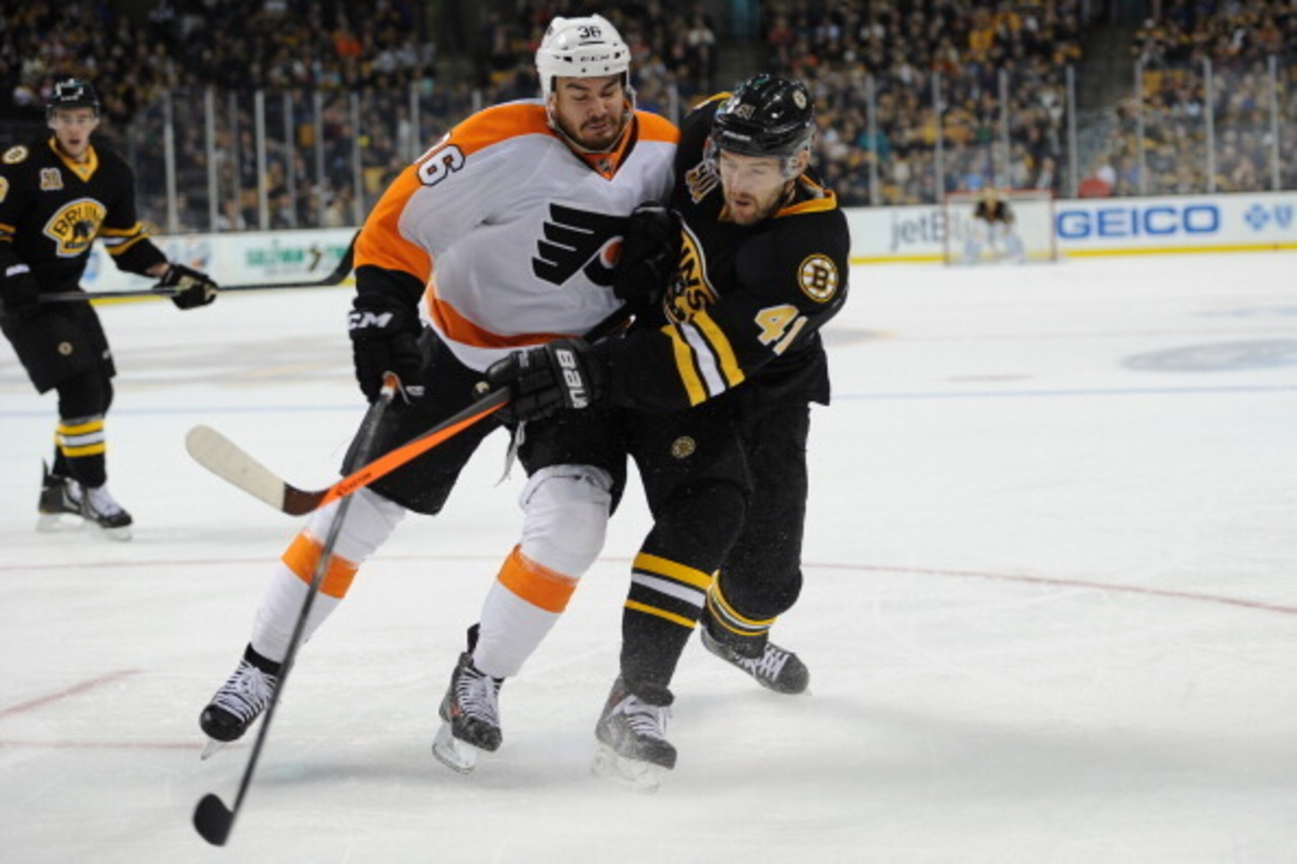 BOSTON, MA - APRIL 5: Andrej Meszaros #41 of the Boston Bruins shoots the puck against Zac Rinaldo #36 of the Philadelphia Flyers at the TD Garden on April 5, 2014 in Boston, Massachusetts.  (Photo by Brian Babineau/NHLI via Getty Images)