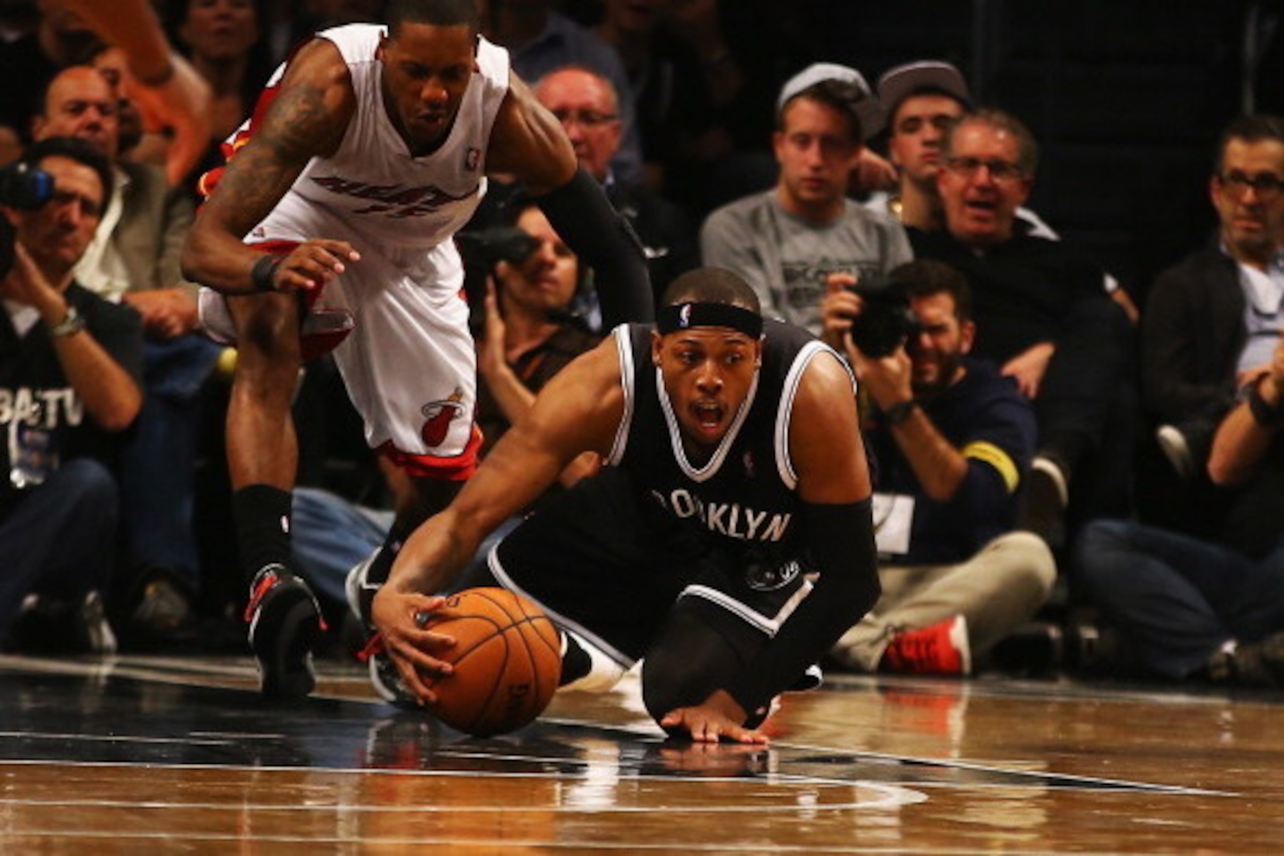 NEW YORK, NY - NOVEMBER 01:  Paul Pierce #34 of the Brooklyn Nets dives for the ball as Mario Chalmers #15 of the Miami Heat defends during their game at the Barclays Center on November 1, 2013 in the Brooklyn borough of New York City. NOTE TO USER: User 