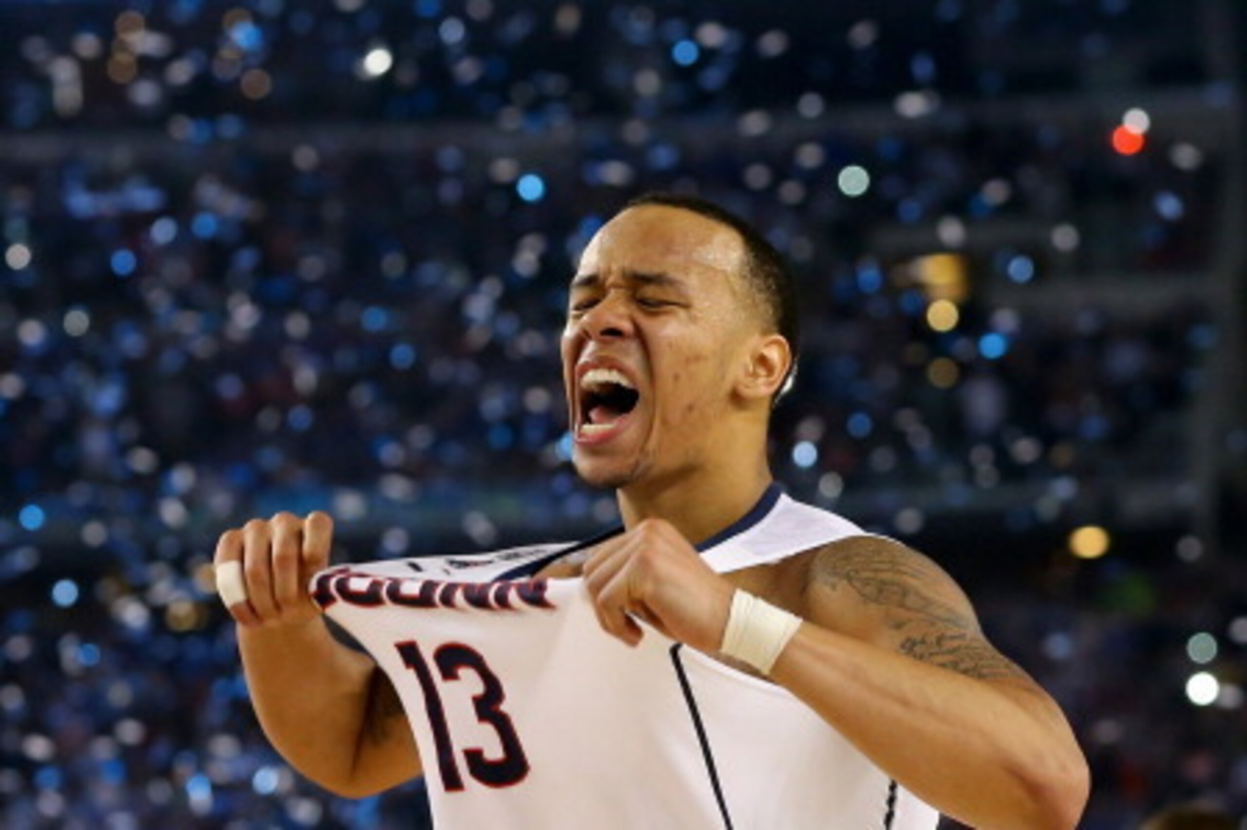 ARLINGTON, TX - APRIL 07:  Shabazz Napier #13 of the Connecticut Huskies celebrates on the court after defeating the Kentucky Wildcats 60-54 in the NCAA Men's Final Four Championship at AT&T Stadium on April 7, 2014 in Arlington, Texas.  (Photo by Ronald 