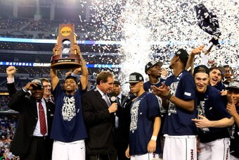ARLINGTON, TX - APRIL 07: Ryan Boatright #11 of the Connecticut Huskies holds up the trophy after defeating the Kentucky Wildcats 60-54 in the NCAA Men's Final Four Championship at AT&T Stadium on April 7, 2014 in Arlington, Texas.  (Photo by Jamie Squire