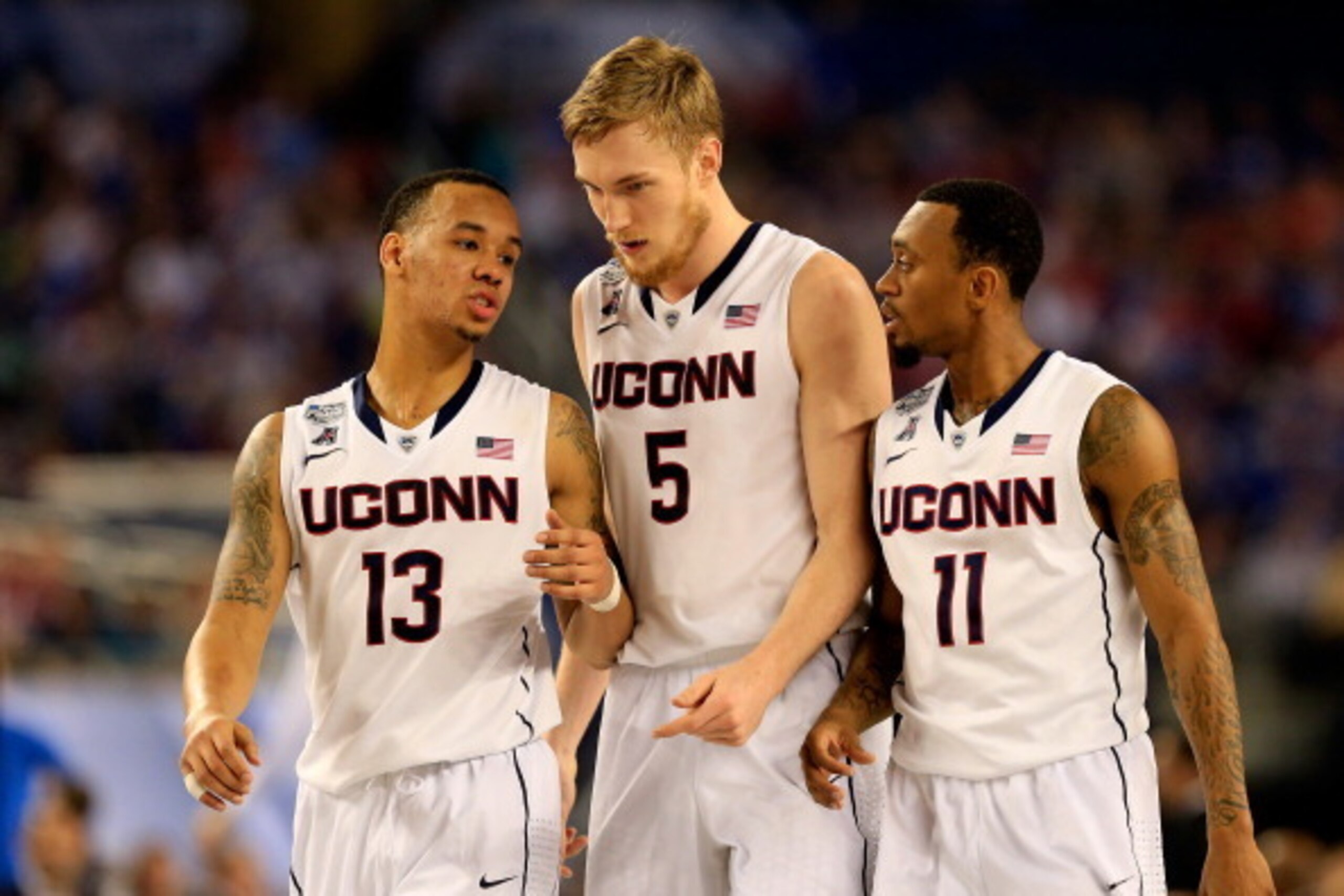ARLINGTON, TX - APRIL 07: Shabazz Napier #13 speaks with Niels Giffey #5 and Ryan Boatright #11 during the NCAA Men's Final Four Championship against the Kentucky Wildcats at AT&T Stadium on April 7, 2014 in Arlington, Texas.  (Photo by Jamie Squire/Getty