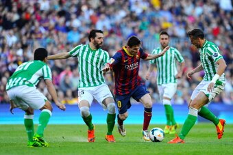 BARCELONA, SPAIN - APRIL 05:  Lionel Messi of FC Barcelona duels for the ball with Jordi Figueras (2ndL) and Antonio Amaya (R) of Real Betis Balompie during the La Liga match between FC Barcelona and Real Betis Balompie at Camp Nou on April 5, 2014 in Bar