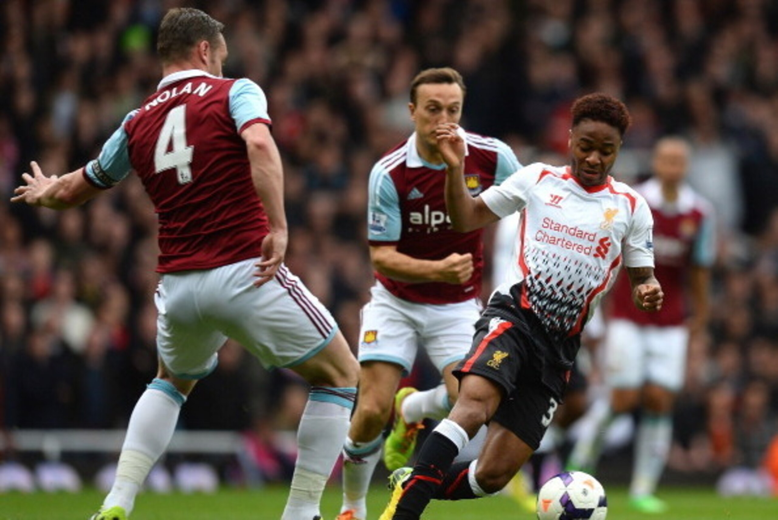LONDON, ENGLAND - APRIL 06:  Raheem Sterling of Liverpool is challenged by Kevin Nolan of West Ham during the Barclays Premier League match between West Ham United and Liverpool at Boleyn Ground on April 6, 2014 in London, England.  (Photo by Mike Hewitt/