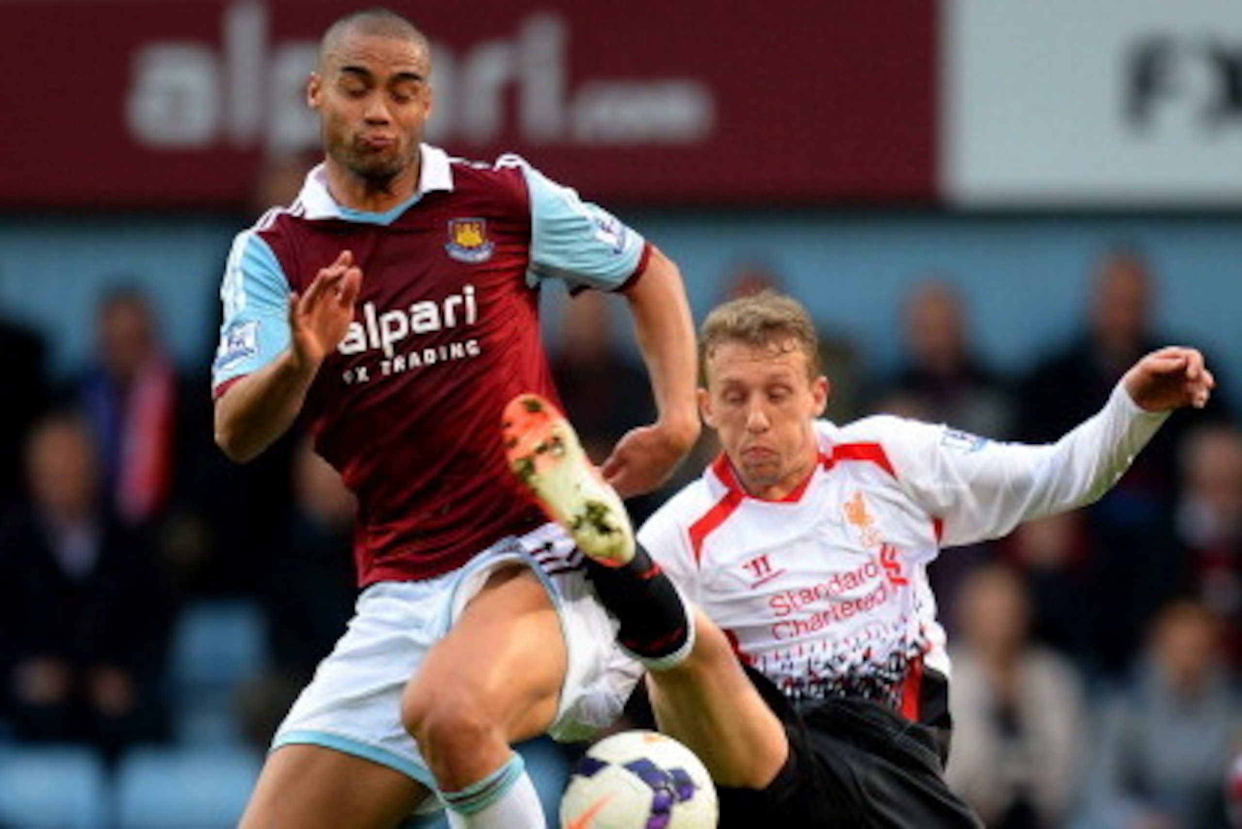 LONDON, ENGLAND - APRIL 06:  Winston Reid of West Ham and Lucas Leiva of Liverpool compete for the ball during the Barclays Premier League match between West Ham United and Liverpool at Boleyn Ground on April 6, 2014 in London, England.  (Photo by Mike He