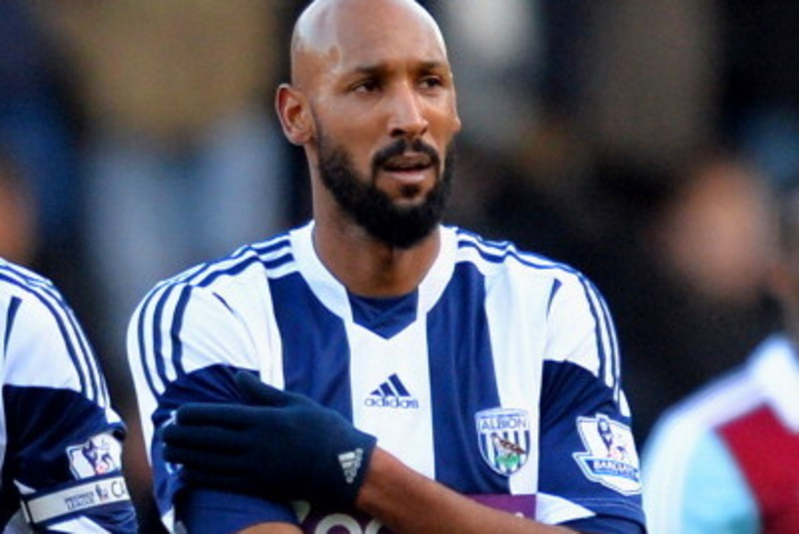 LONDON, ENGLAND - DECEMBER 28:  Nicolas Anelka of West Brom touches his sleeve as he celebrates scoring their first goal during the Barclays Premier League match between West Ham United and West Bromwich Albion at Boleyn Ground on December 28, 2013 in Lon