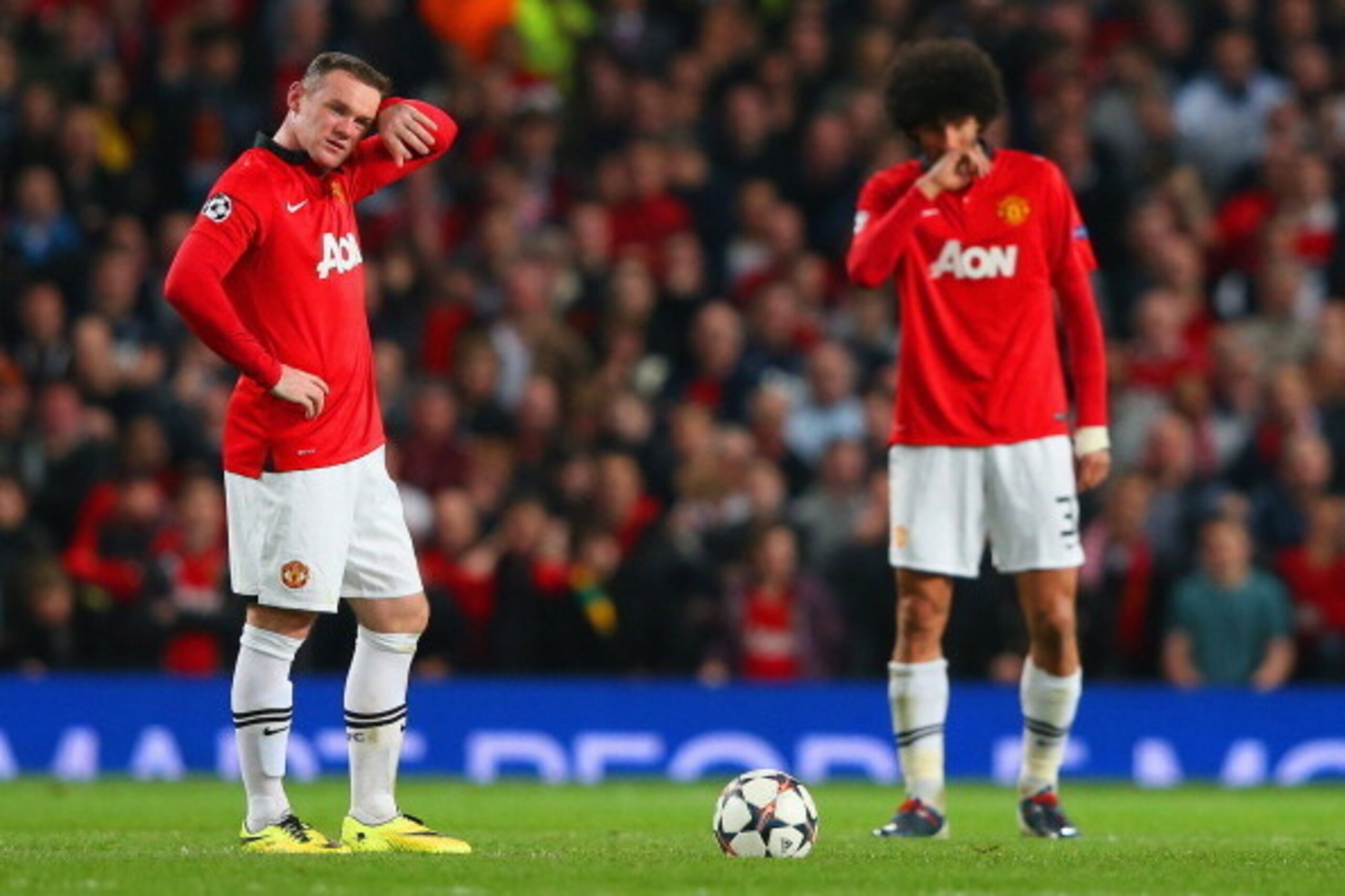MANCHESTER, ENGLAND - APRIL 01:  A dejected Wayne Rooney of Manchester United and Marouane Fellaini of Manchester United look on after conceding a goal during the UEFA Champions League Quarter Final first leg match between Manchester United and FC Bayern 