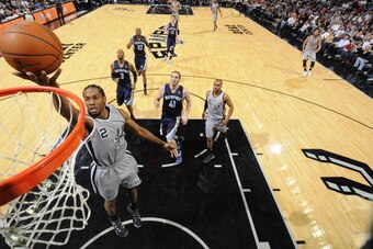 SAN ANTONIO, TX - April 6: Kawhi Leonard #2 of the San Antonio Spurs goes up for a shot against the Memphis Grizzlies at the AT&T Center on April 6, 2014 in San Antonio, Texas. NOTE TO USER: User expressly acknowledges and agrees that, by downloading and 