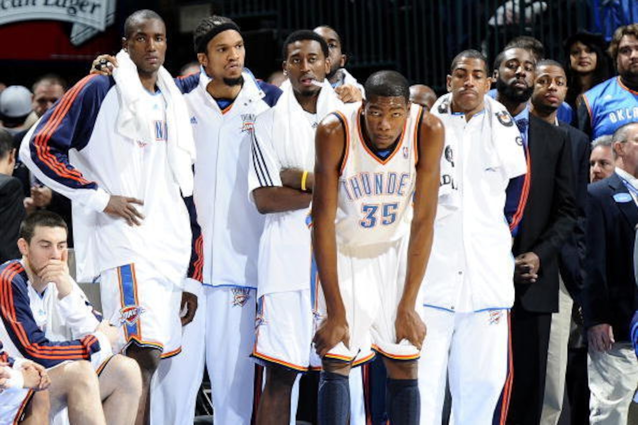 OKLAHOMA CITY, OK - MARCH 22:  (L-R) Nick Collison #4, Serge Ibaka #9, Etan Thomas #36, Kyle Weaver #5, Kevin Durant #35, Kevin Ollie #7 and James Harden #13 of the Oklahoma City Thunder watch the action from the sidelines during the game against the San 