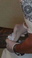 A nurse inserting the PICC line.