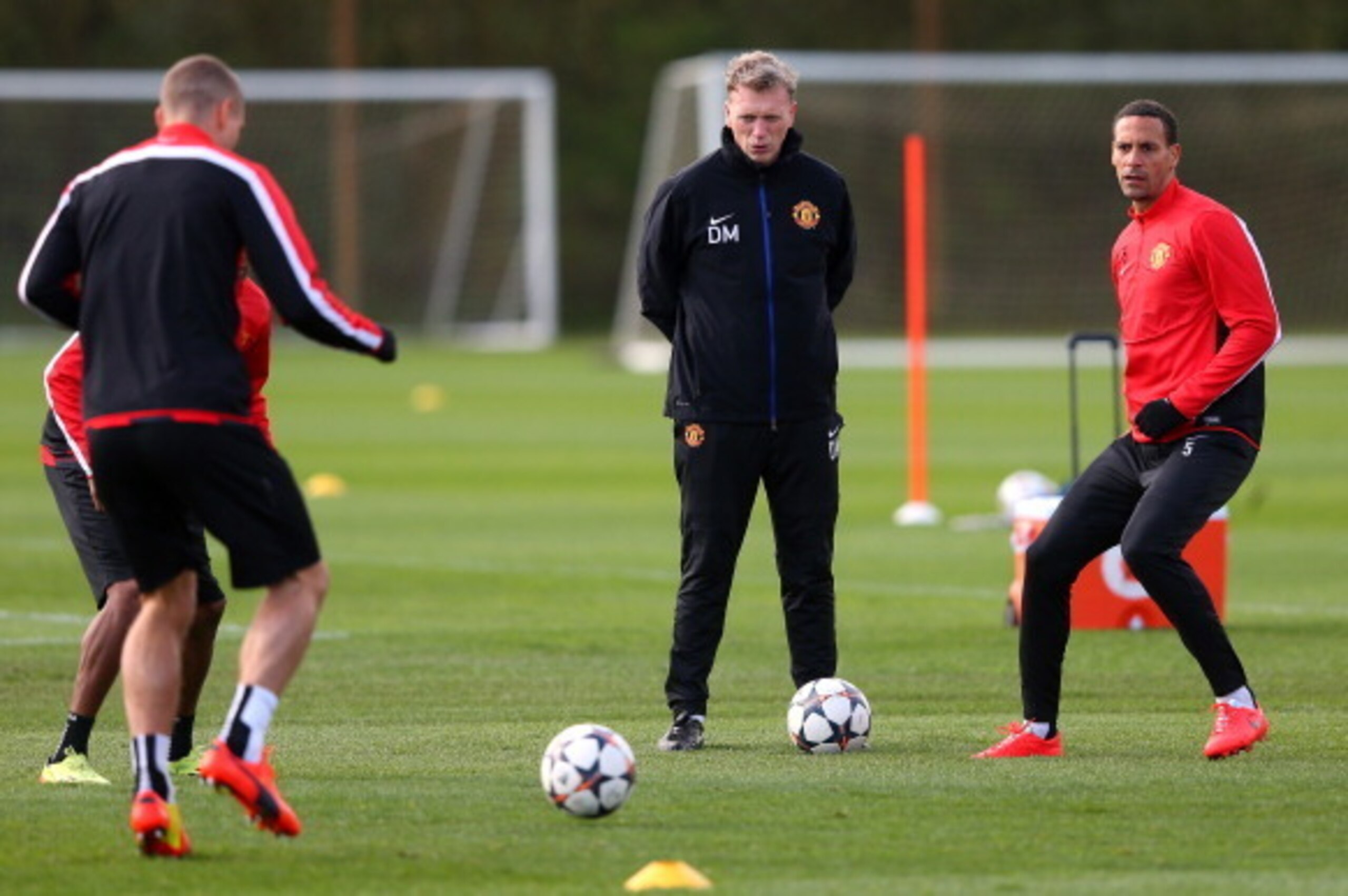 MANCHESTER, ENGLAND - APRIL 08:  David Moyes the manager of Manchester United looks on as Rio Ferdinand passes the ball during a training session at Aon Training Complex on April 8, 2014 in Manchester, England.  (Photo by Alex Livesey/Getty Images)