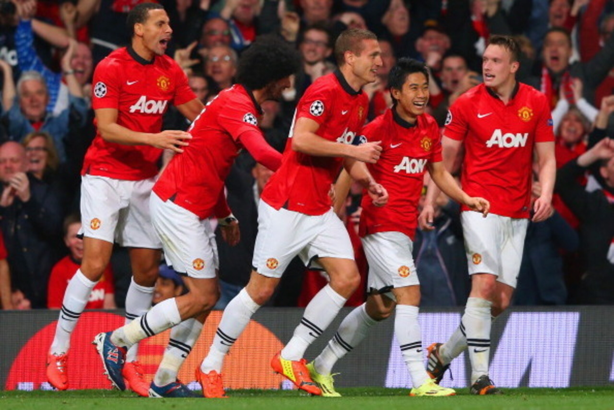 MANCHESTER, ENGLAND - APRIL 01: Nemanja Vidic of Manchester United celebrates with team mates after scoring their first goal during the UEFA Champions League Quarter Final first leg match between Manchester United and FC Bayern Muenchen at Old Trafford on