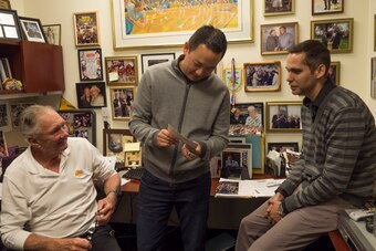 Ryan West (right) checks out memorabilia with Kevin Ding and Bill Bertka in Bertka's office.