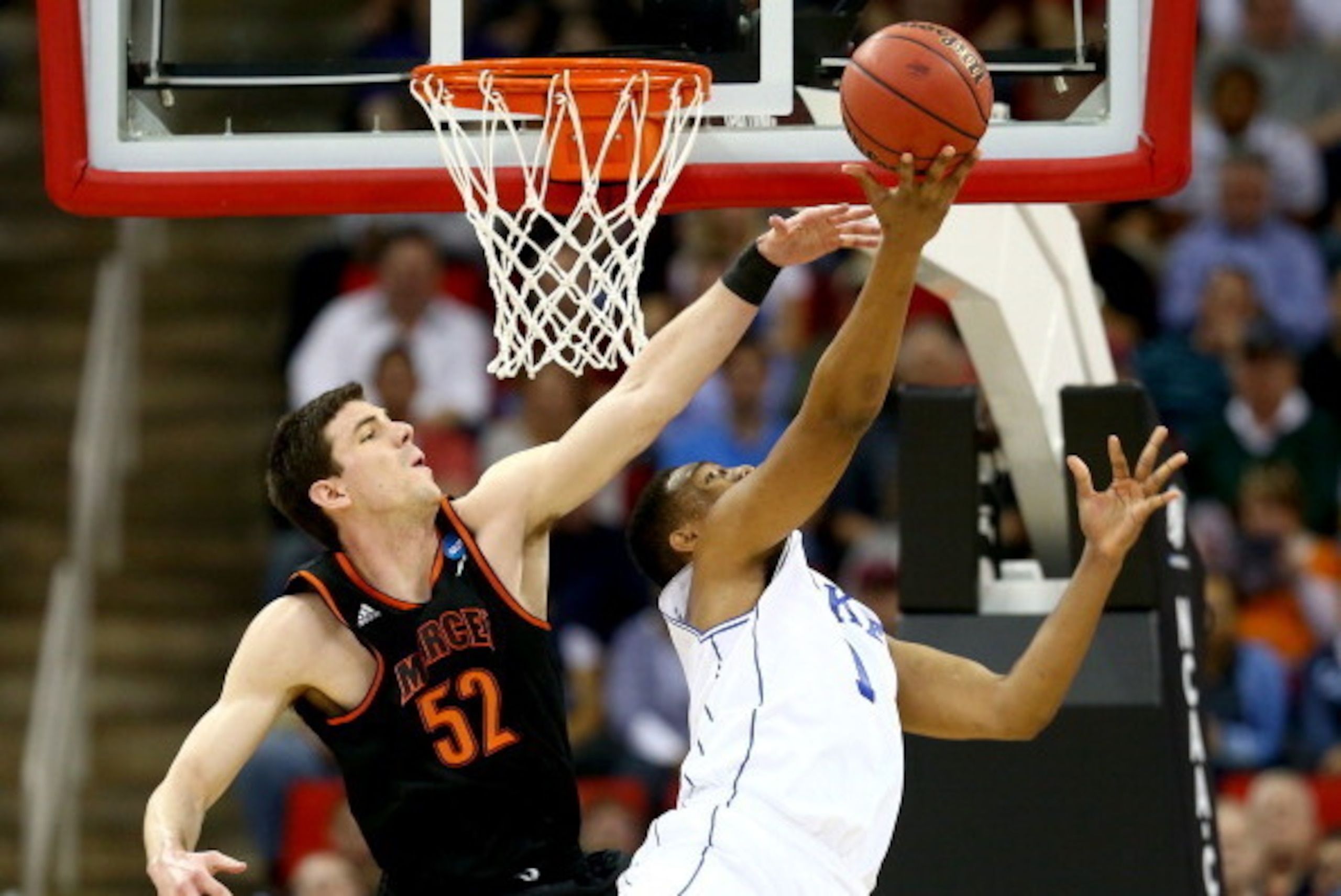 RALEIGH, NC - MARCH 21:  Jabari Parker #1 of the Duke Blue Devils goes up for a shot against Daniel Coursey #52 of the Mercer Bears in the first half in the second round of the 2014 NCAA Men's Basketball Tournament at PNC Arena on March 21, 2014 in Raleig