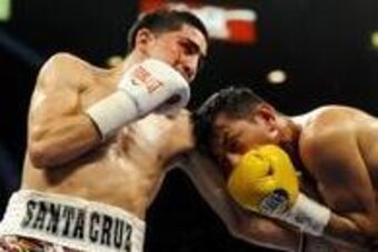 Mar 8, 2014; Las Vegas, NV, USA; Leo Santa Cruz (white gloves) trades punches with Cristian Mijares (yellow gloves) during their super bantamweight title bout at MGM Grand Arena. Mandatory Credit: Stephen R. Sylvanie-USA TODAY Sports