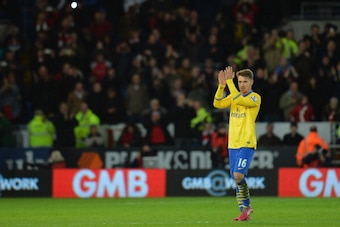 CARDIFF, WALES - NOVEMBER 30:  Aaron Ramsey of Arsenal appaulds both sets of fans after the match during the Barclays Premier League match between Cardiff City and Arsenal at Cardiff City Stadium on November 30, 2013 in Cardiff, Wales.  (Photo by Christop