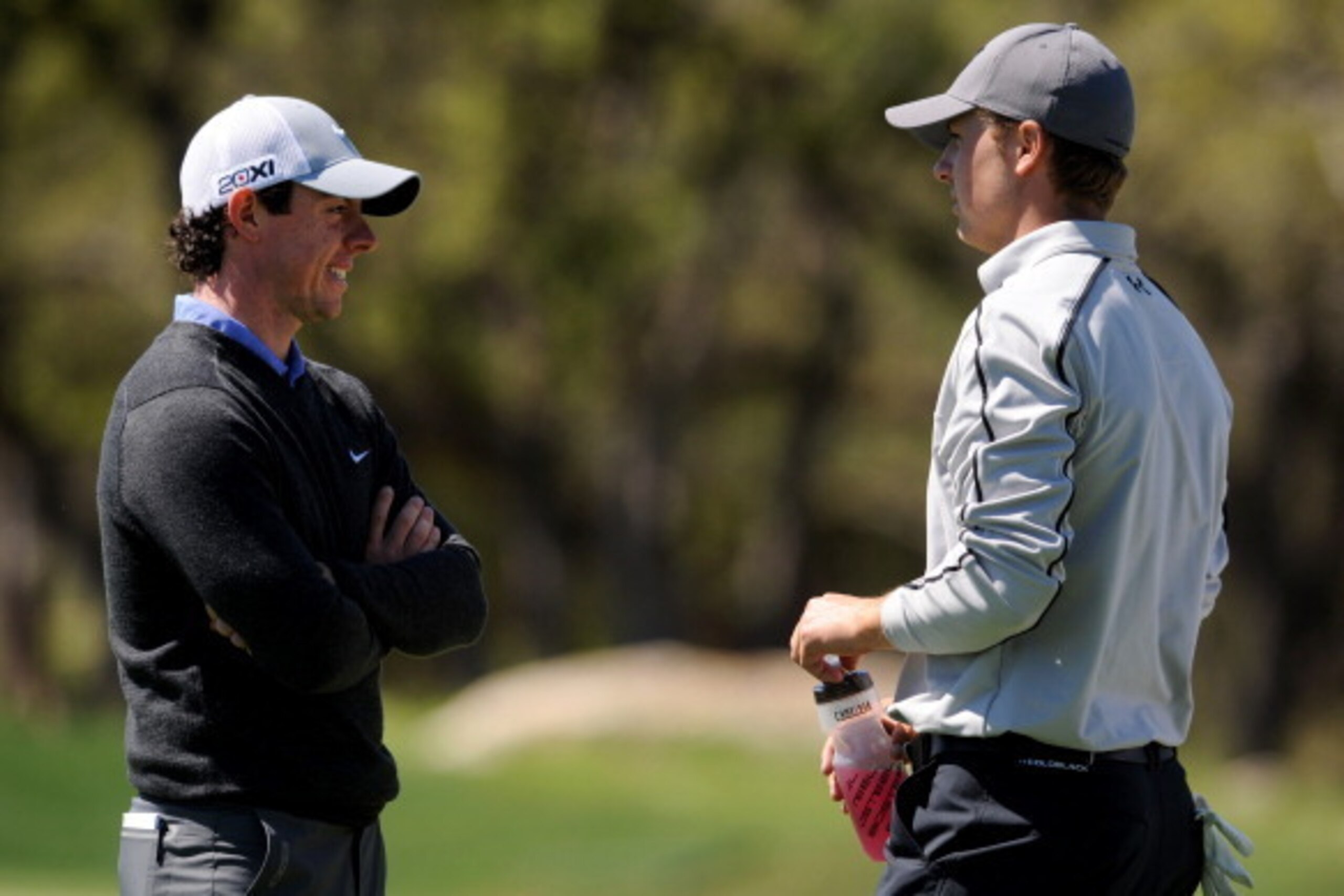 SAN ANTONIO, TX - APRIL 04:  Rory McIlroy of Northern Ireland talks with Jordan Spieth on the 6th hole during the first round of the Valero Texas Open at the AT&T Oaks Course at TPC San Antonio on April 04, 2013 in San Antonio, Texas. (Photo by Steve Dyke