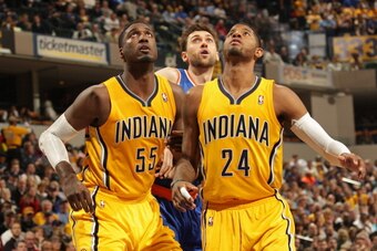 INDIANAPOLIS - JANUARY 16:  Roy Hibbert #55 and Paul George #24 of the Indiana Pacers box out Andrea Bargnani #77 of the New York Knicks at Bankers Life Fieldhouse on January 14, 2014 in Indianapolis, Indiana.  NOTE TO USER: User expressly acknowledges an