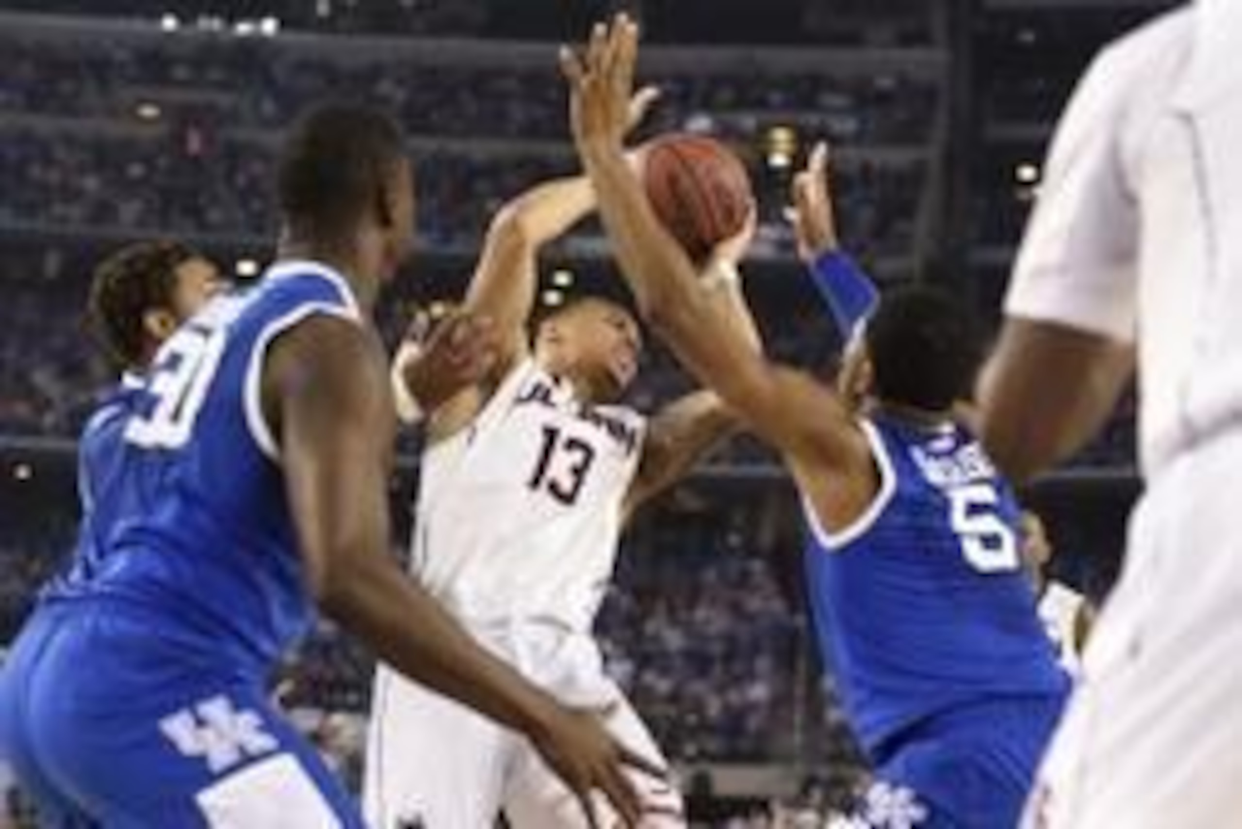 Apr 7, 2014; Arlington, TX, USA; Connecticut Huskies guard Shabazz Napier (13) is trapped by Kentucky Wildcats guard Andrew Harrison (5),  James Young (1) and Julius Randle (30) in the second half during the championship game of the Final Four in the 2014