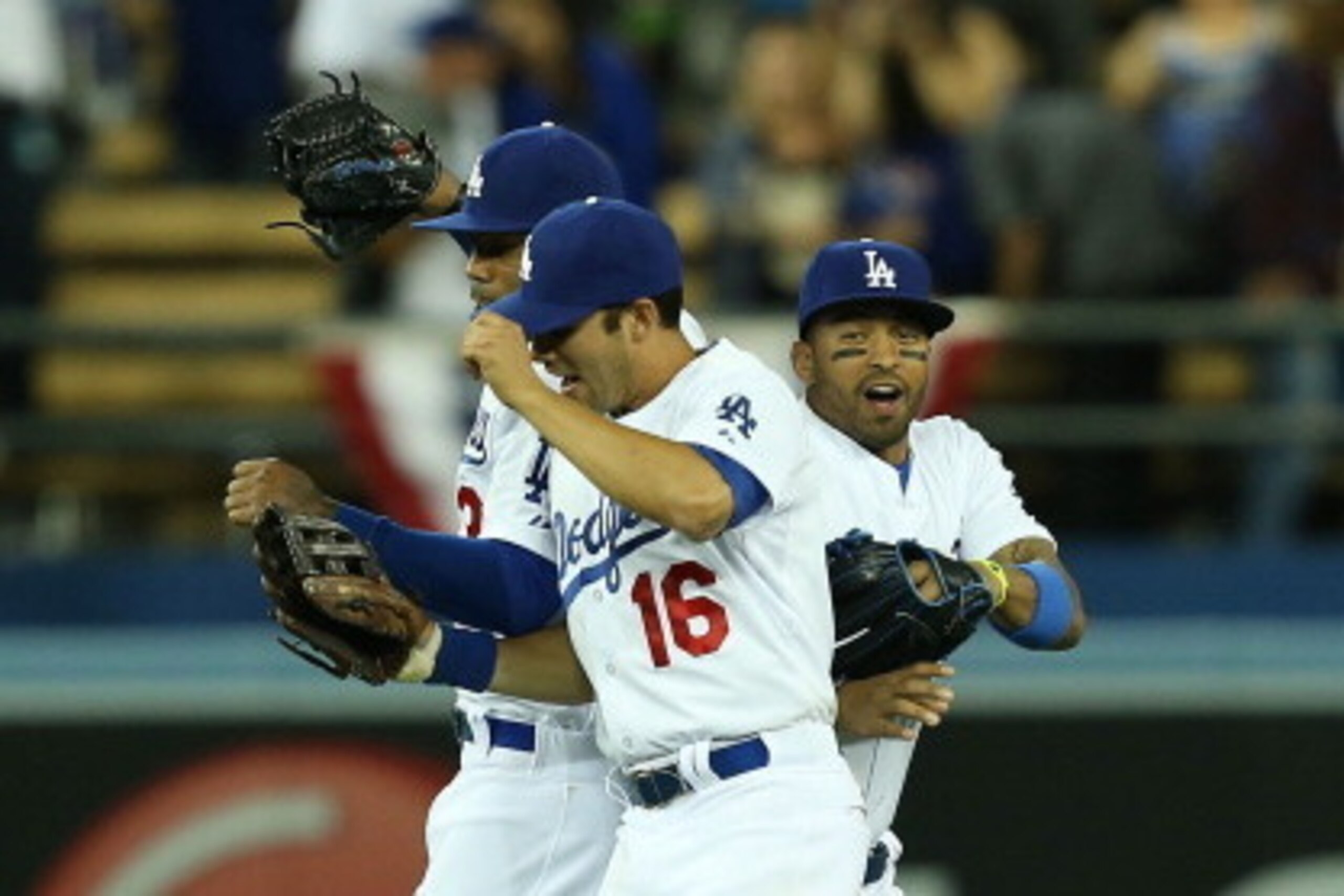 LOS ANGELES, CA - APRIL 06:  (L-R) Carl Crawford #3, Andre Ethier #16 and Matt Kemp #27 of the Los Angeles Dodgers celebrate at center field after defeating the San Francisco Giants 6-2 in the MLB game at Dodger Stadium on April 6, 2014 in Los Angeles, Ca