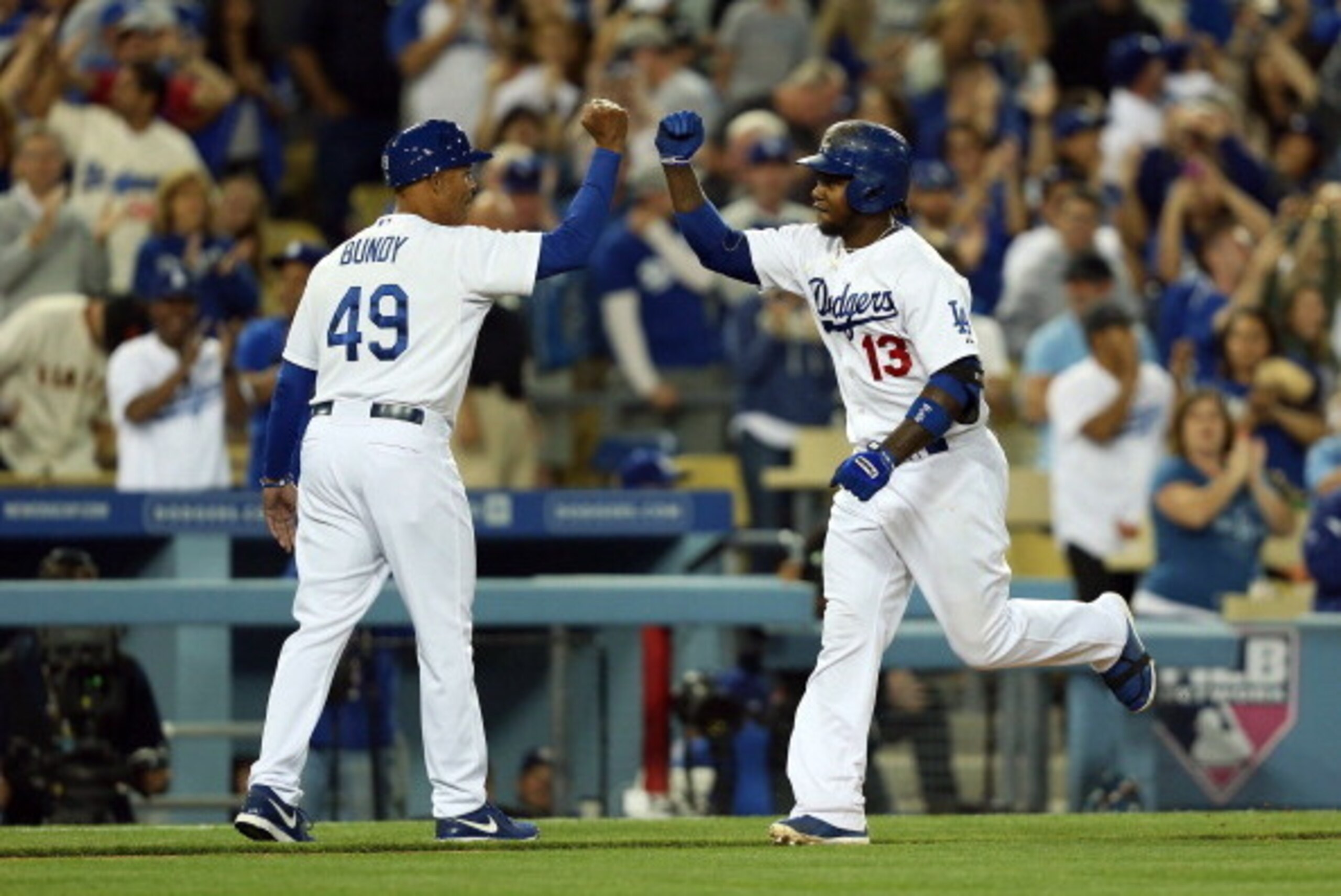 LOS ANGELES, CA - APRIL 06:  Hanley Ramirez #13 of the Los Angeles Dodgers celebrates with third base coach Lorenzo Bundy #49 after hitting a solo home run in the eighth inning against the San Francisco Giants during the MLB game at Dodger Stadium on Apri
