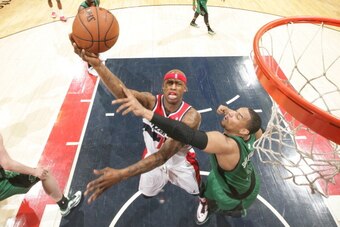 WASHINGTON, DC - APRIL 2: Al Harrington #7 of the Washington Wizards shoots against Jared Sullinger #7 of the Boston Celtics during the game at the Verizon Center on April 2, 2014 in Washington, DC. NOTE TO USER: User expressly acknowledges and agrees tha