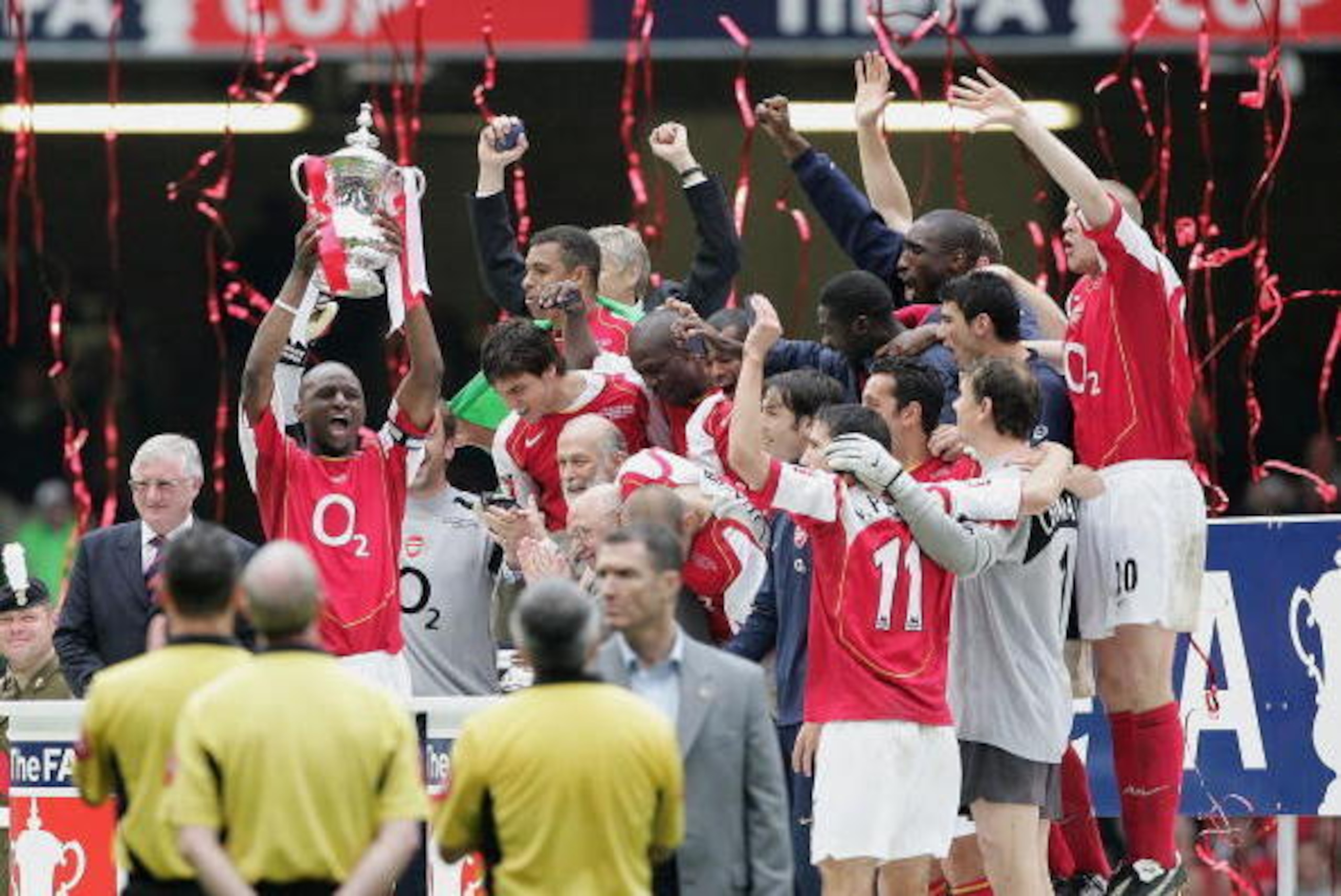 CARDIFF, UNITED KINGDOM - MAY 21: Arsenal captain, Patrick Vieira, holds the trophy aloft as team mates celebrate after winning the FA Cup Final between Arsenal and Manchester United 5-4 on penalty's at The Millennium Stadium on May 21, 2005 in Cardiff, W CARDIFF, UNITED KINGDOM - MAY 21: Arsenal captain, Patrick Vieira, holds the trophy aloft as team mates celebrate after winning the FA Cup Final between Arsenal and Manchester United 5-4 on penalty's at The Millennium Stadium on May 21, 2005 in Cardiff, W