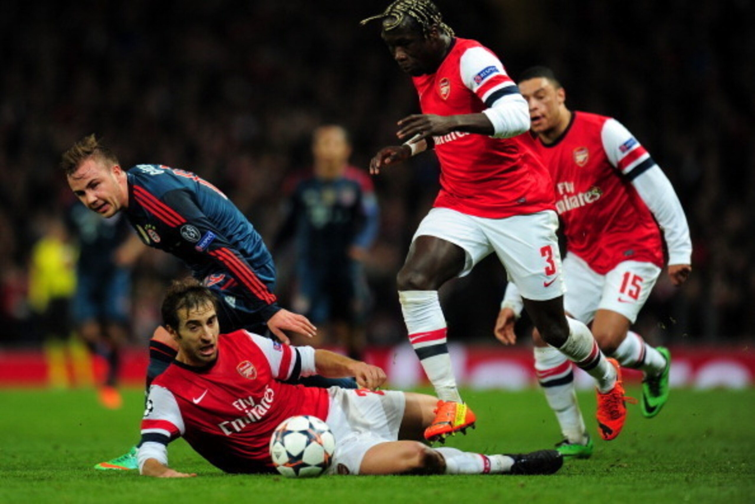 LONDON, ENGLAND - FEBRUARY 19: Mario Goetze of Bayern Muenchen clashes with Mathieu Flamini and Bacary Sagna of Arsenal during the UEFA Champions League Round of 16 first leg match between Arsenal and FC Bayern Muenchen at Emirates Stadium on February 19 LONDON, ENGLAND - FEBRUARY 19: Mario Goetze of Bayern Muenchen clashes with Mathieu Flamini and Bacary Sagna of Arsenal during the UEFA Champions League Round of 16 first leg match between Arsenal and FC Bayern Muenchen at Emirates Stadium on February 19