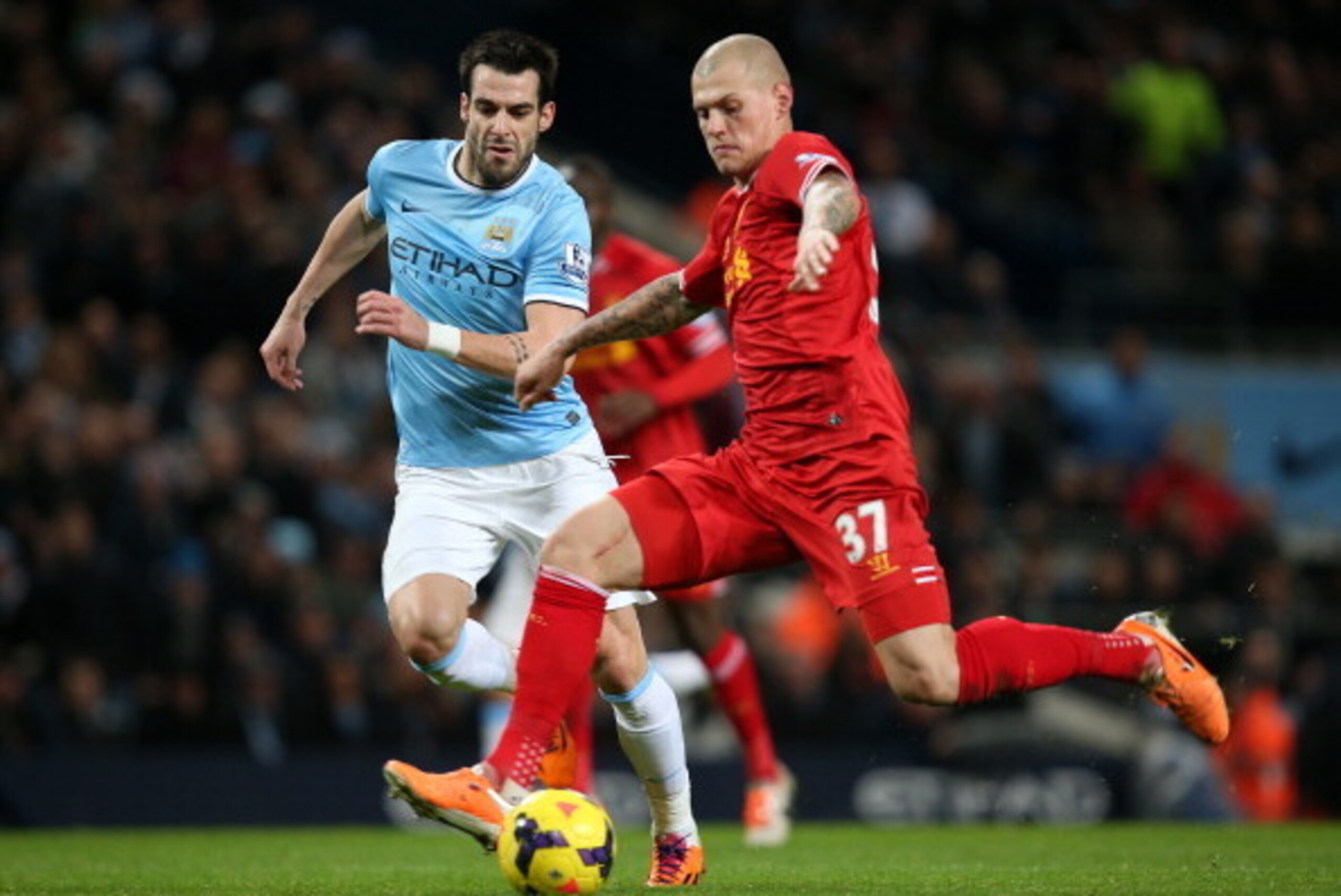MANCHESTER, ENGLAND - DECEMBER 26:  Martin Skrtel of Liverpool steers the ball clear of Alvaro Negredo of Manchester City during the Barclays Premier League match between Manchester City and Liverpool at the Etihad Stadium on December 26, 2013 in Manchest