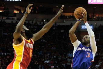 HOUSTON, TX - MARCH 29:  Chris Paul #3 of the Los Angeles Clippers shoots over James Harden #13 of the Houston Rockets during the game at the Toyota Center on March 29, 2014 in Houston, Texas. NOTE TO USER: User expressly acknowledges and agrees that, by 