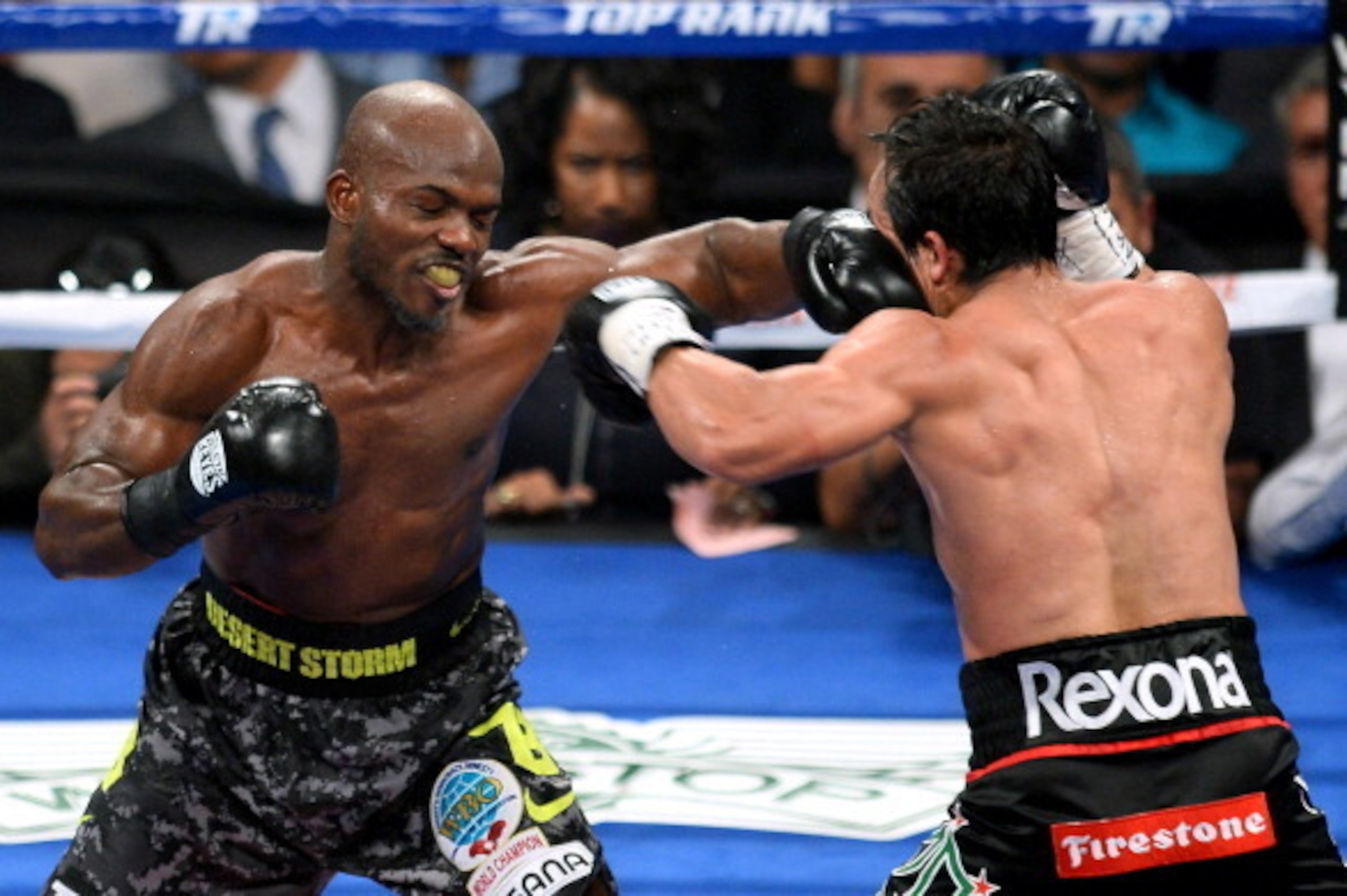 LAS VEGAS, NV - OCTOBER 12:  WBO welterweight champion Timothy Bradley Jr. (L) hits Juan Manuel Marquez in the seventh round of their bout at the Thomas & Mack Center on October 12, 2013 in Las Vegas, Nevada. Bradley won in a split decision.  (Photo by Et