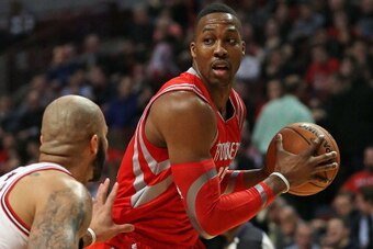CHICAGO, IL - MARCH 13:  Dwight Howard #12 of the Houston Rockets looks to pass over carlos Boozer #5 of the Chicago Bulls at the United Center on March 13, 2014 in Chicago, Illinois. NOTE TO USER: User expressly acknowledges and agrees that, by downloadi