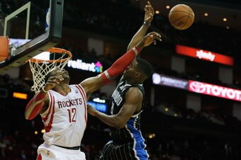 HOUSTON, TX - DECEMBER 08:  Dwight Howard #12 of the Houston Rockets blocks a shot from Maurice Harkless #21 of the Orlando Magic at Toyota Center on December 8, 2013 in Houston, Texas. NOTE TO USER: User expressly acknowledges and agrees that, by downloa