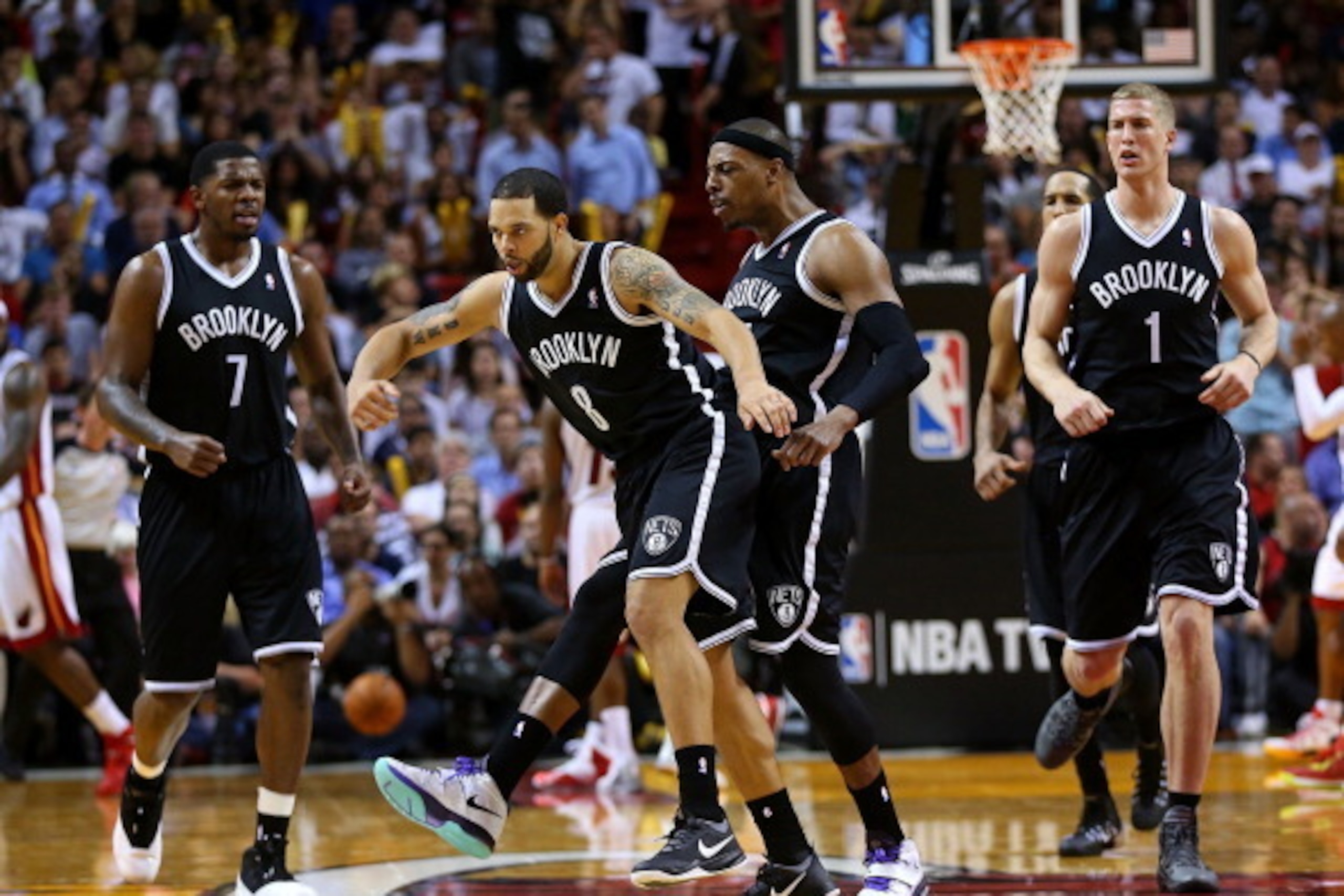 MIAMI, FL - MARCH 12: Deron Williams #8 and Paul Pierce #34 of the Brooklyn Nets celebrate a play during a game against the Miami Heat at American Airlines Arena on March 12, 2014 in Miami, Florida. NOTE TO USER: User expressly acknowledges and agrees tha