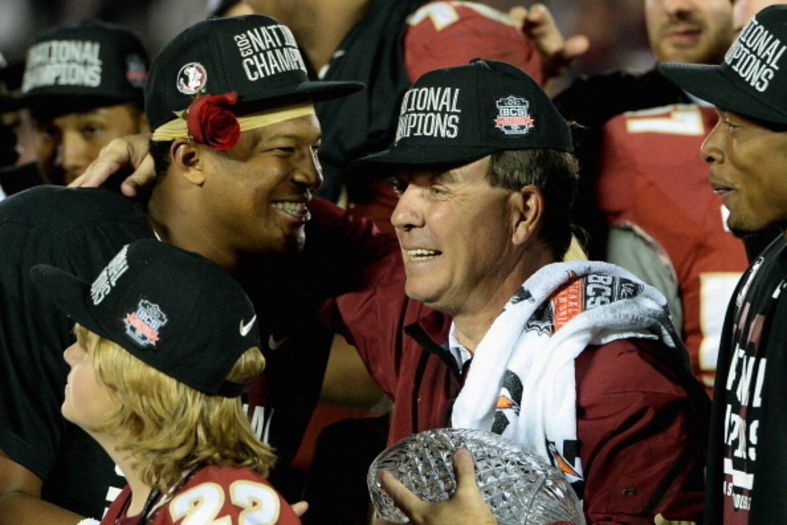 PASADENA, CA - JANUARY 06:  Florida State Seminoles head coach Jimbo Fisher (R) holds the Coaches' Trophy as quarterback Jameis Winston (L) #5 looks on after defeating the Auburn Tigers 34-31 in the 2014 Vizio BCS National Championship Game at the Rose Bo