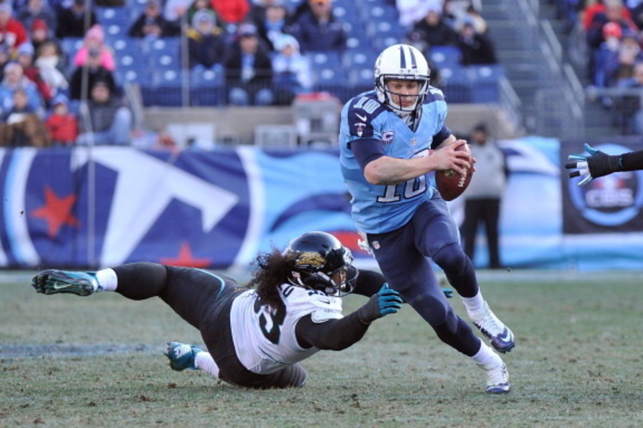 NASHVILLE, TN - DECEMBER 30:  Tyson Alualu #93 of the Jacksonville Jaguars dives to try to sack quarterback Jake Locker #10 of the Tennessee Titans at LP Field on December 30, 2012 in Nashville, Tennessee.  (Photo by Frederick Breedon/Getty Images)
