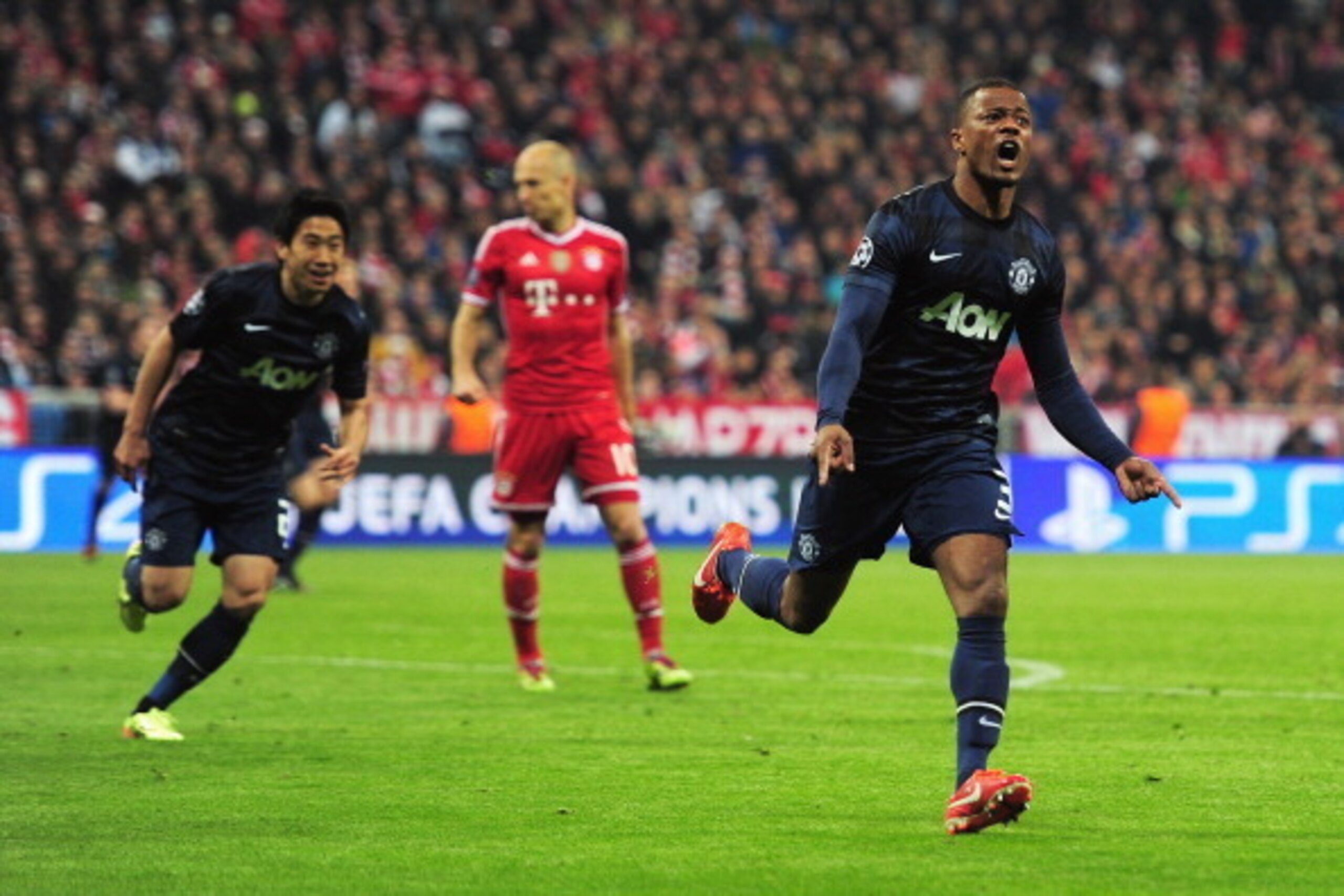MUNICH, GERMANY - APRIL 09:  Patrice Evra (R) of Manchester United celebrates his goal during the UEFA Champions League Quarter Final second leg match between FC Bayern Muenchen and Manchester United at Allianz Arena on April 9, 2014 in Munich, Germany.