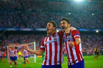 MADRID, SPAIN - APRIL 09:  Koke of Club Atletico de Madrid celebrates scoring the opening goal with David Villa of Club Atletico de Madrid  during the UEFA Champions League Quarter Final second leg match between Club Atletico de Madrid and FC Barcelona at