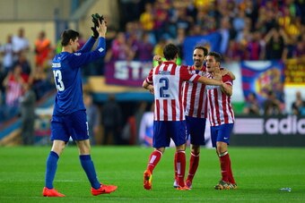 MADRID, SPAIN - APRIL 09:  Diego Godin, Juanfran and Koke of Club Atletico de Madrid hug as Thibaut Courtois of Club Atletico de Madrid applauds the fans during the UEFA Champions League Quarter Final second leg match between Club Atletico de Madrid and F