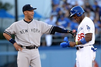 LOS ANGELES, CA - JULY 30:  Derek Jeter #2 of the New York Yankees jokes with Yasiel Puig #66 of the Los Angeles Dodgers after a double during the first inning at Dodger Stadium on July 30, 2013 in Los Angeles, California.  (Photo by Harry How/Getty Image