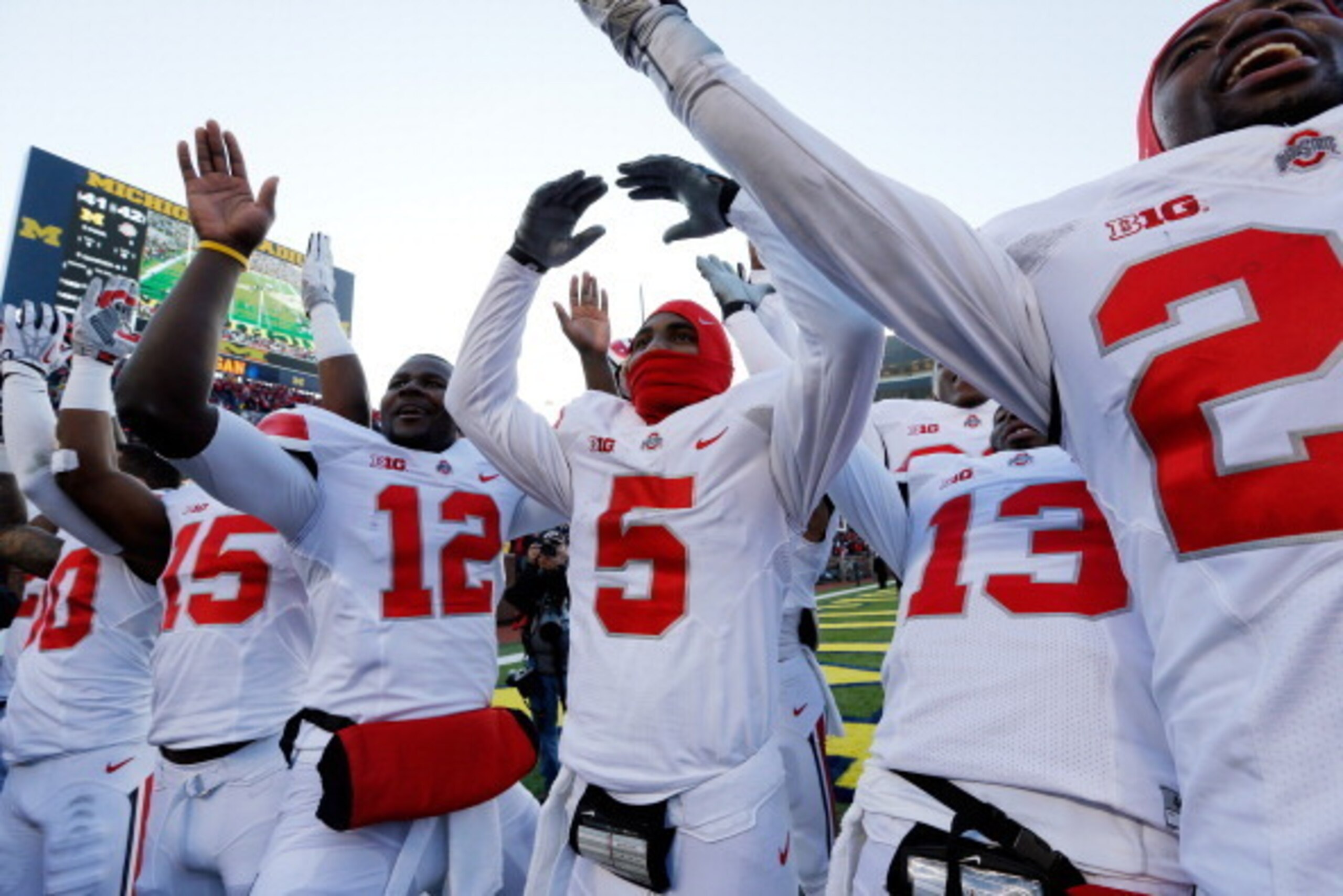 ANN ARBOR, MI - NOVEMBER 30: Quarterback Braxton Miller #5 of the Ohio State Buckeyes celebrates on the field with quarterback Kenny Guiton #13 and quarterback Cardale Jones #12 after defeating the Michigan Wolverines 42-41 in a game at Michigan Stadium ANN ARBOR, MI - NOVEMBER 30: Quarterback Braxton Miller #5 of the Ohio State Buckeyes celebrates on the field with quarterback Kenny Guiton #13 and quarterback Cardale Jones #12 after defeating the Michigan Wolverines 42-41 in a game at Michigan Stadium