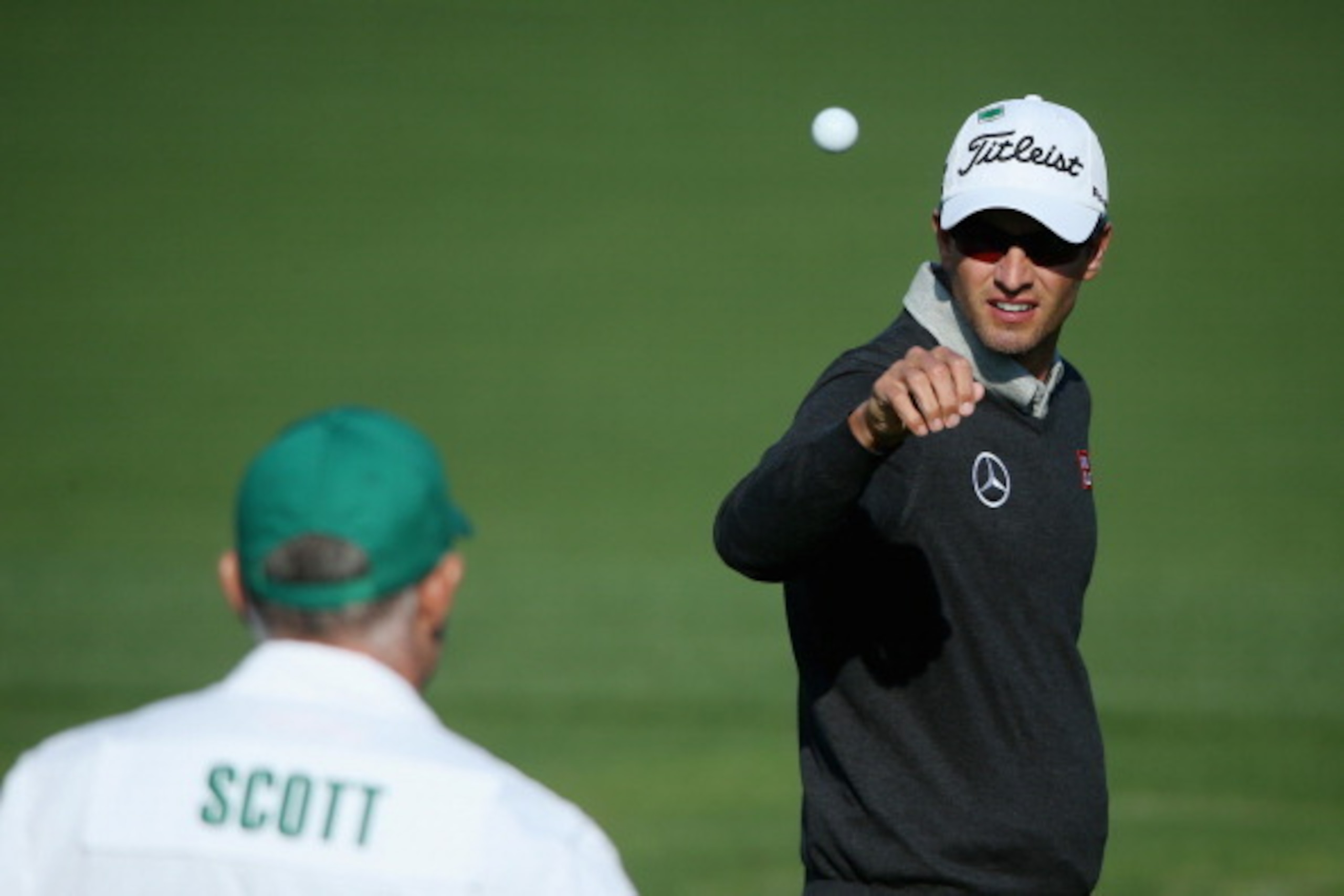 AUGUSTA, GA - APRIL 09:  Adam Scott of Australia reaches for a golf ball on the practice ground during a practice round prior to the start of the 2014 Masters Tournament at Augusta National Golf Club on April 9, 2014 in Augusta, Georgia.  (Photo by Andrew