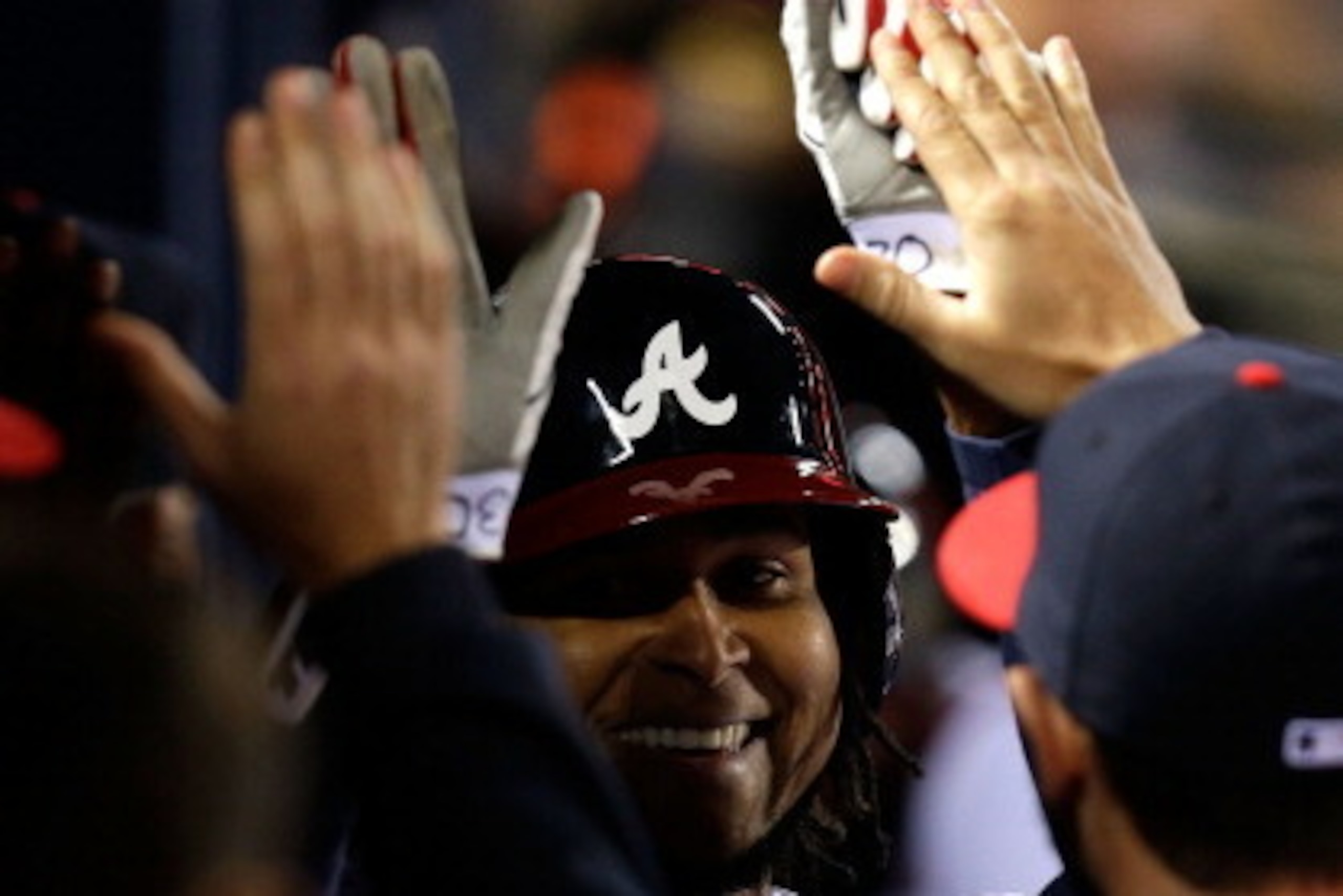 ATLANTA, GA - APRIL 09:  Pitcher Ervin Santana #30 of the Atlanta Braves is congratulated in the dugout after scoring during the game against the New York Mets at Turner Field on April 9, 2014 in Atlanta, Georgia.  (Photo by Mike Zarrilli/Getty Images)