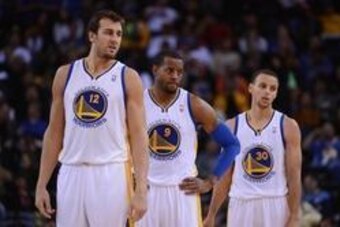 October 24, 2013; Oakland, CA, USA; Golden State Warriors center Andrew Bogut (12), shooting guard Andre Iguodala (9), and point guard Stephen Curry (30) look on during the fourth quarter against the Portland Trail Blazers at Oracle Arena. The Trail Blaze