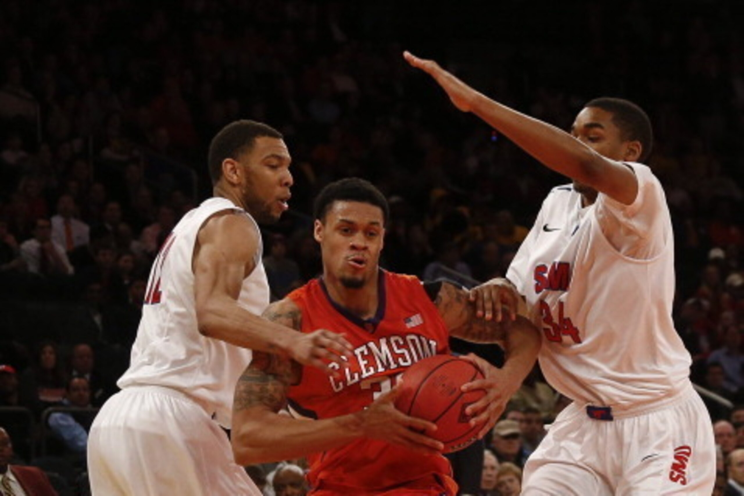 NEW YORK, NY - APRIL 1:   K.J. McDaniels #32 of the Clemson Tigers drives by Ben Moore #34 of the Southern Methodist Mustangs during the NIT Championship semifinals at Madison Square Garden on April 1, 2014 in New York City.  (Photo by Jeff Zelevansky/Get