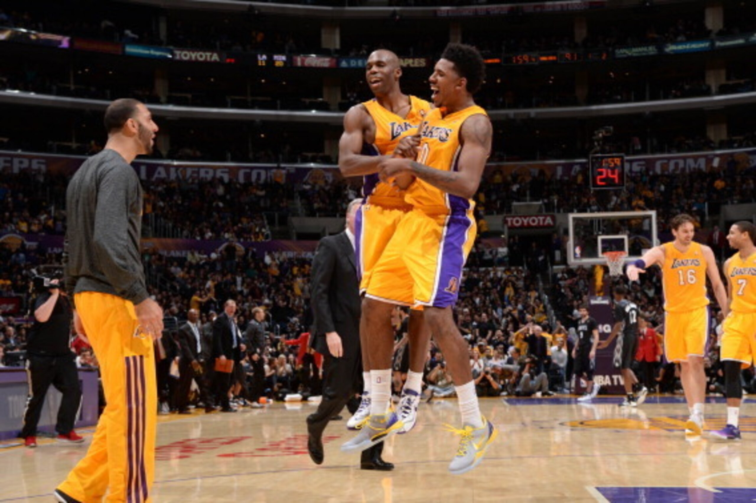 LOS ANGELES, CA - DECEMBER 20: Jodie Meeks #20 and Nick Young #0 of the Los Angeles Lakers celebrate during their game against the Minnesota Timberwolves at Staples Center on December 20, 2013 in Los Angeles, California. NOTE TO USER: User expressly ackno