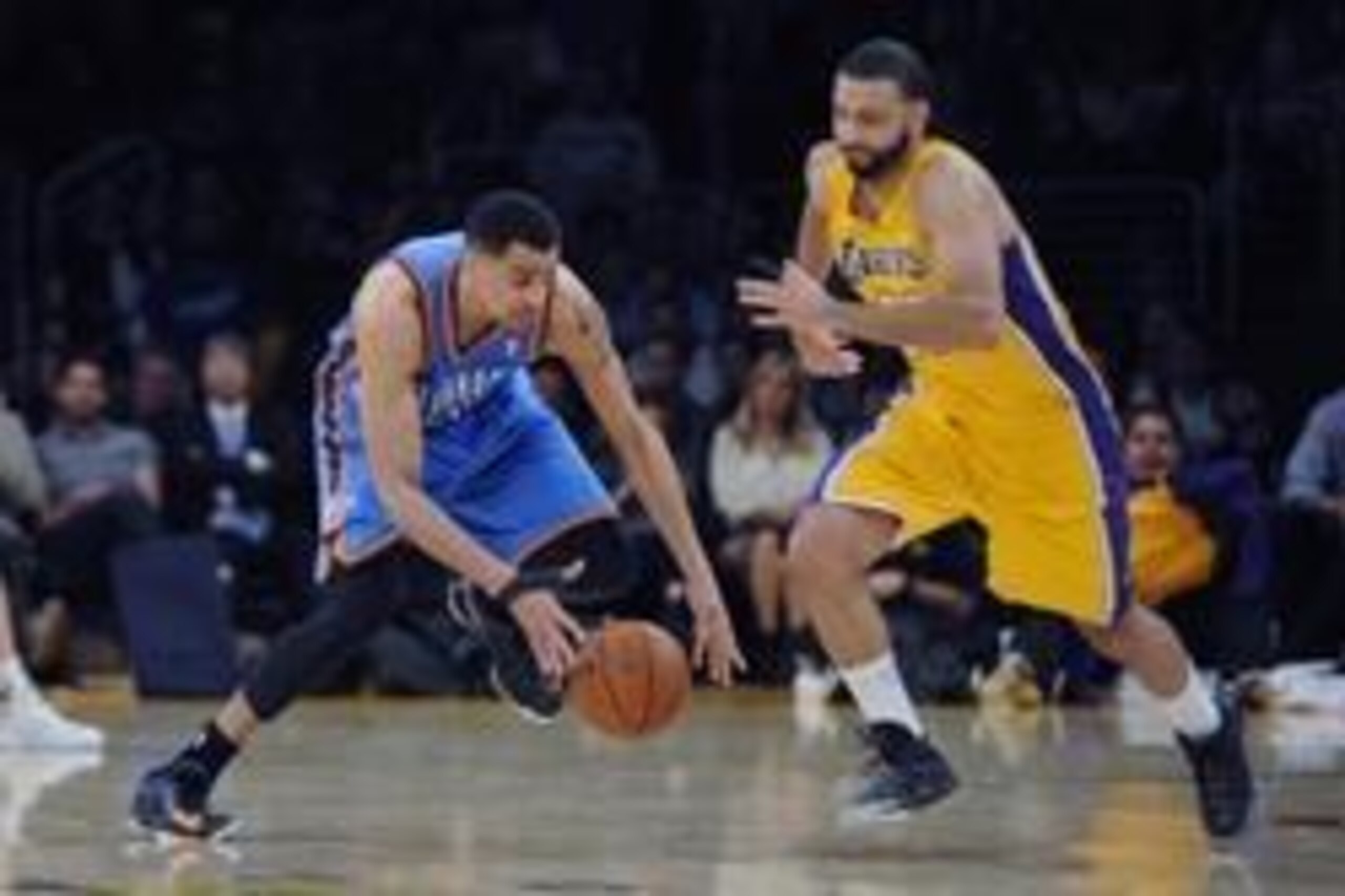 Feb 13, 2014; Los Angeles, CA, USA; Oklahoma City Thunder guard Thabo Sefolosha (25) steals the ball from Los Angeles Lakers guard Kendall Marshall (12) during the second quarter at the Staples Center. Mandatory Credit: Kelvin Kuo-USA TODAY Sports