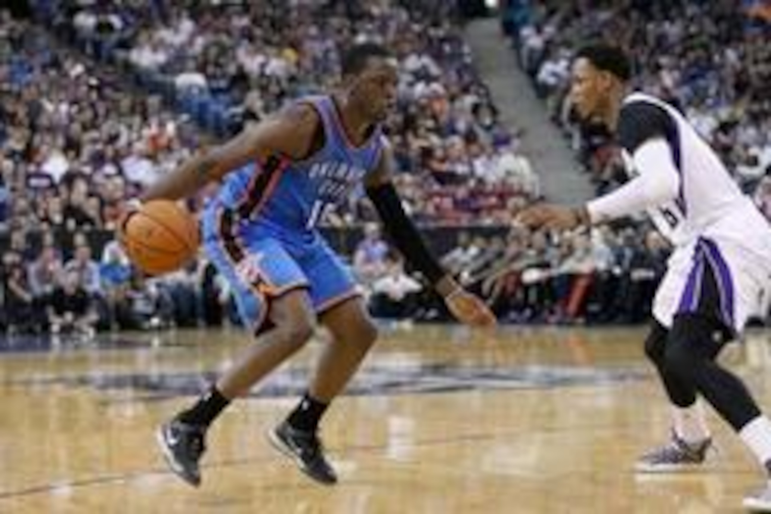 Apr 8, 2014; Sacramento, CA, USA; Oklahoma City Thunder guard Reggie Jackson (15) dribbles the ball next to Sacramento Kings guard Ben McLemore (16) in the third quarter at Sleep Train Arena. The Thunder defeated the Kings 107-92. Mandatory Credit: Cary E