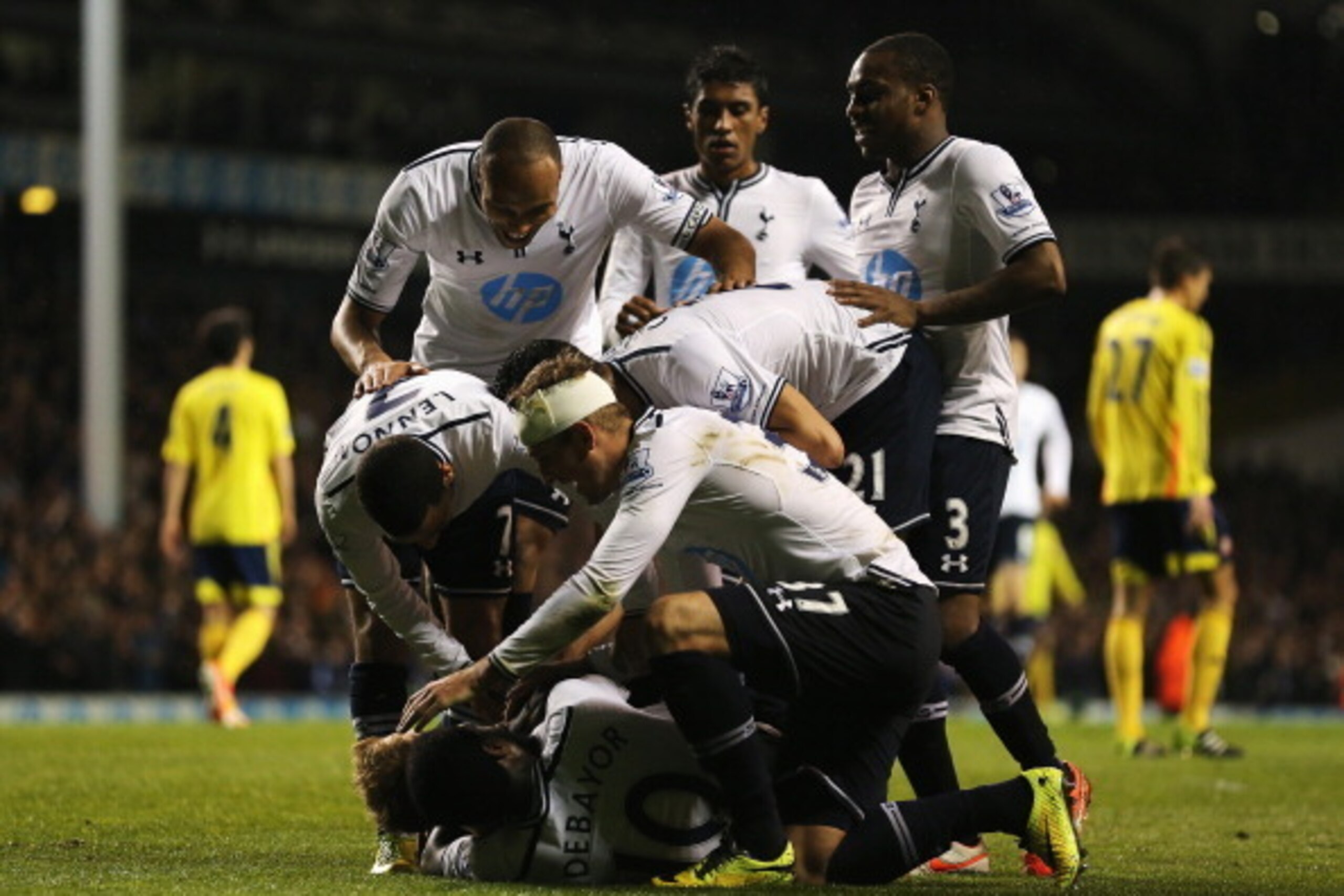 LONDON, ENGLAND - APRIL 07:  Christian Eriksen of Tottenham Hotspur is mobbed by team mates after scoring his team's third goal during the Barclays Premier League match between Tottenham Hotspur and Sunderland at White Hart Lane on April 7, 2014 in London