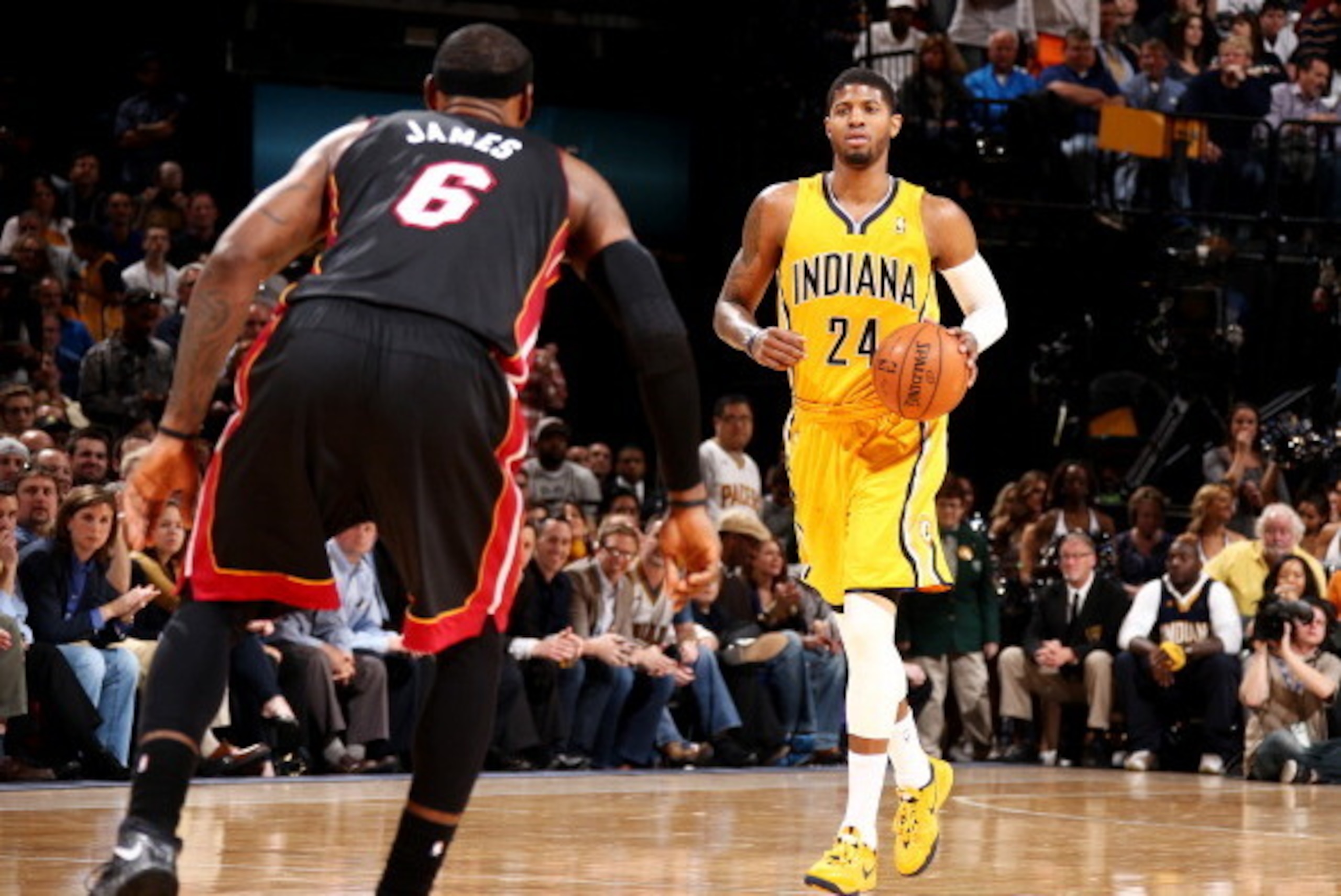 INDIANAPOLIS, IN - MARCH 26: Paul George #24 of the Indiana Pacers brings the ball up court against LeBron James #6 of the Miami Heat during a game on March 26, 2014 at Bankers Life Fieldhouse in Indianapolis, IN.  NOTE TO USER: User expressly acknowledge