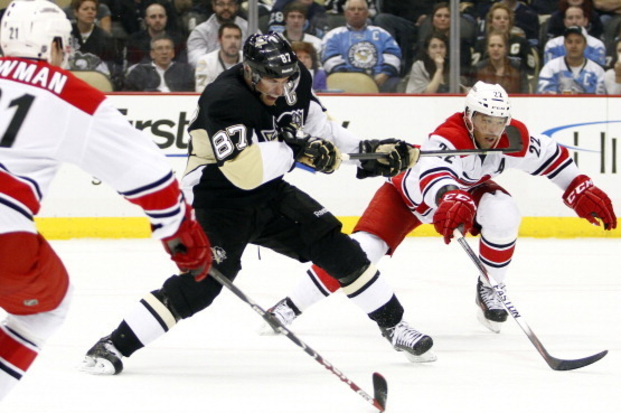 PITTSBURGH, PA - APRIL 01:  Sidney Crosby #87 of the Pittsburgh Penguins shoots a backhand against Manny Malhotra #22 of the Carolina Hurricanes during the game at Consol Energy Center on April 1, 2014 in Pittsburgh, Pennsylvania.  (Photo by Justin K. All